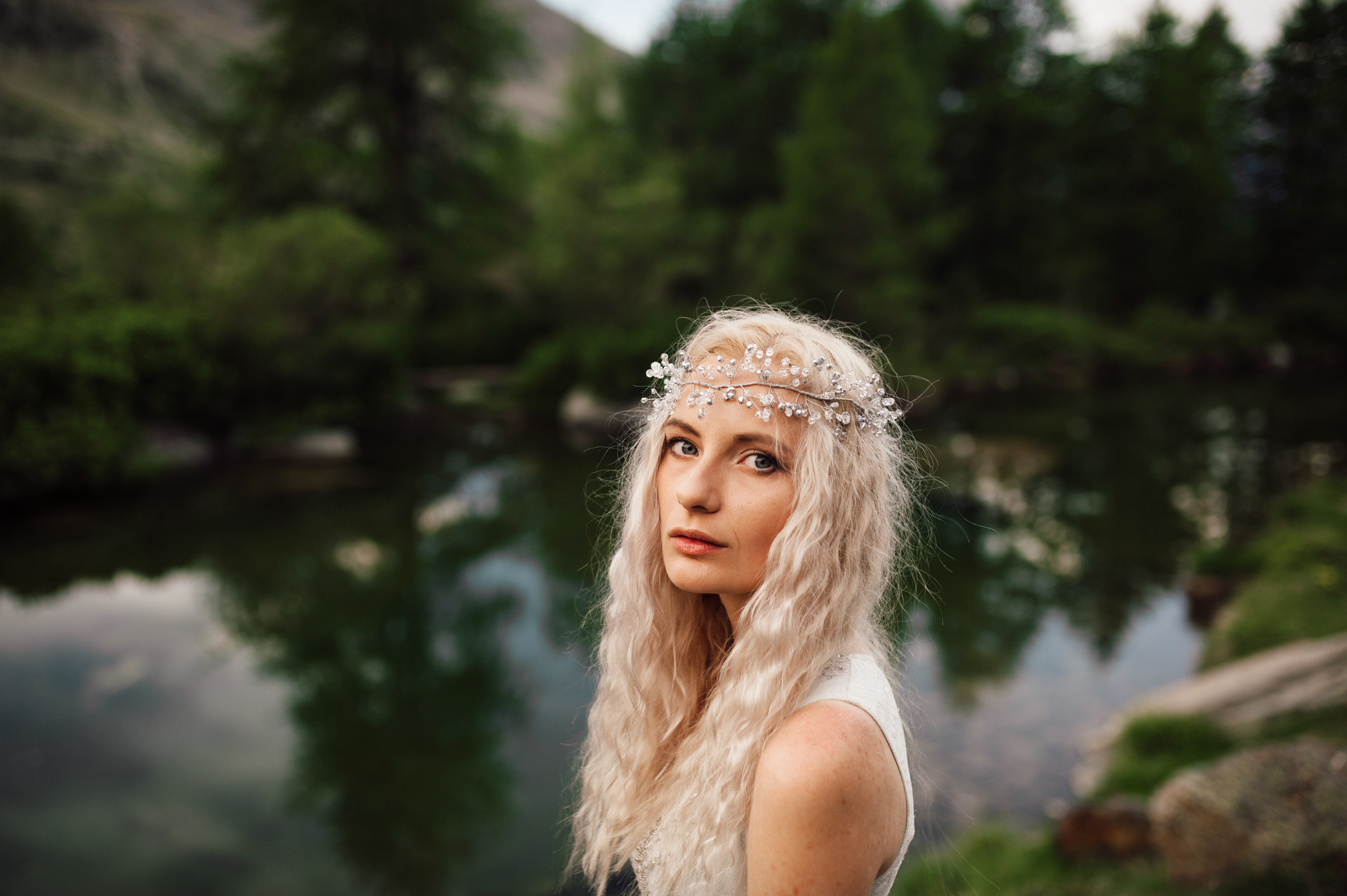 a woman with long blonde hair and a flower crown