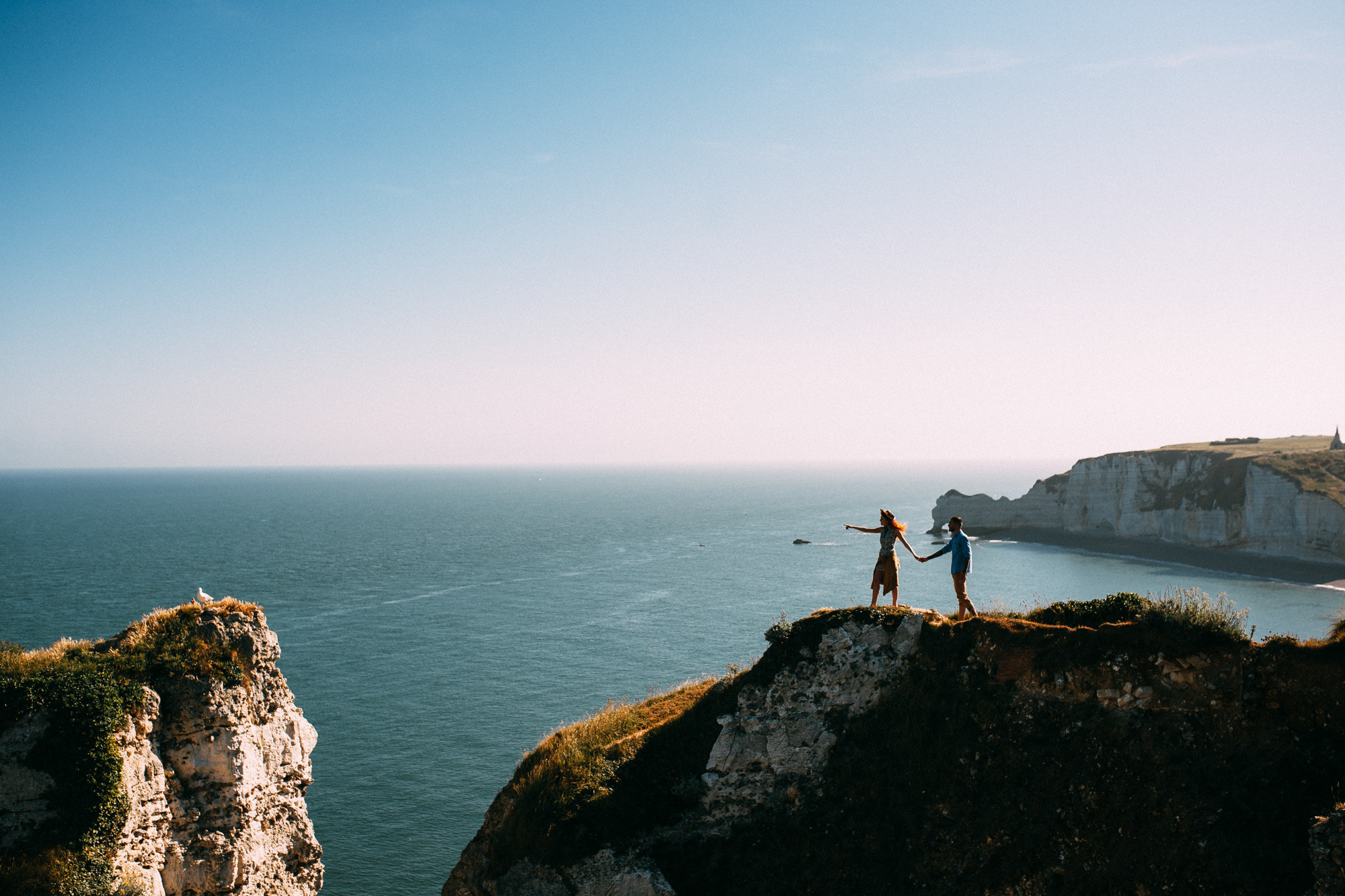 a person standing on a cliff overlooking the ocean