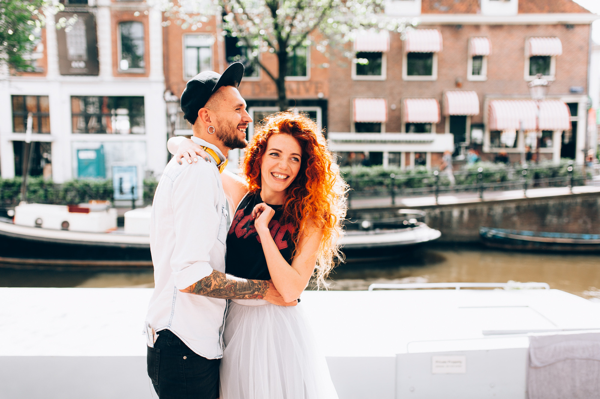 a couple standing next to each other people