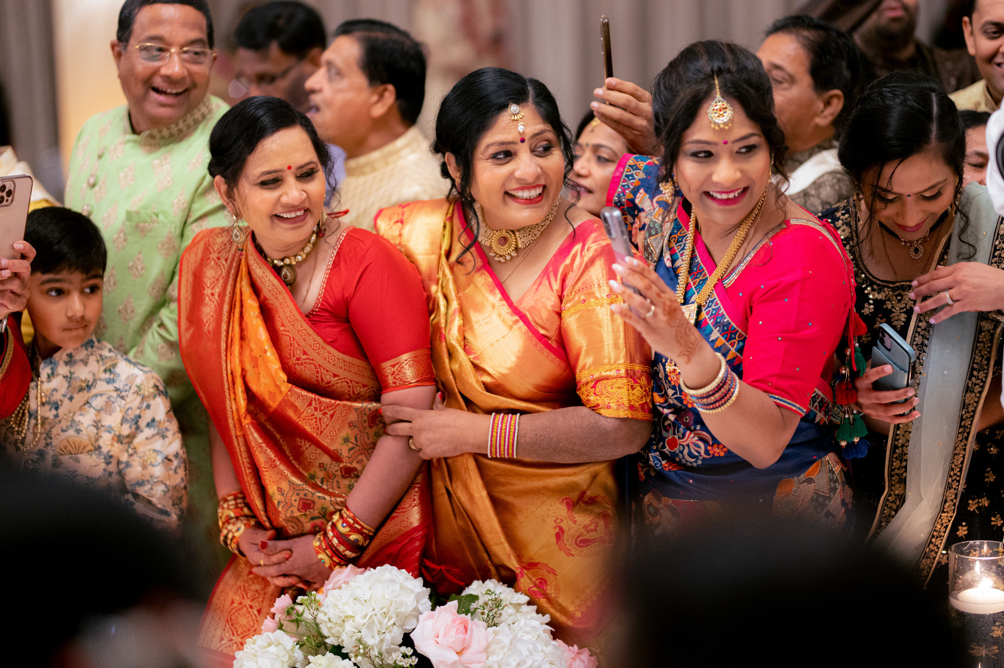 a group of people standing around a table