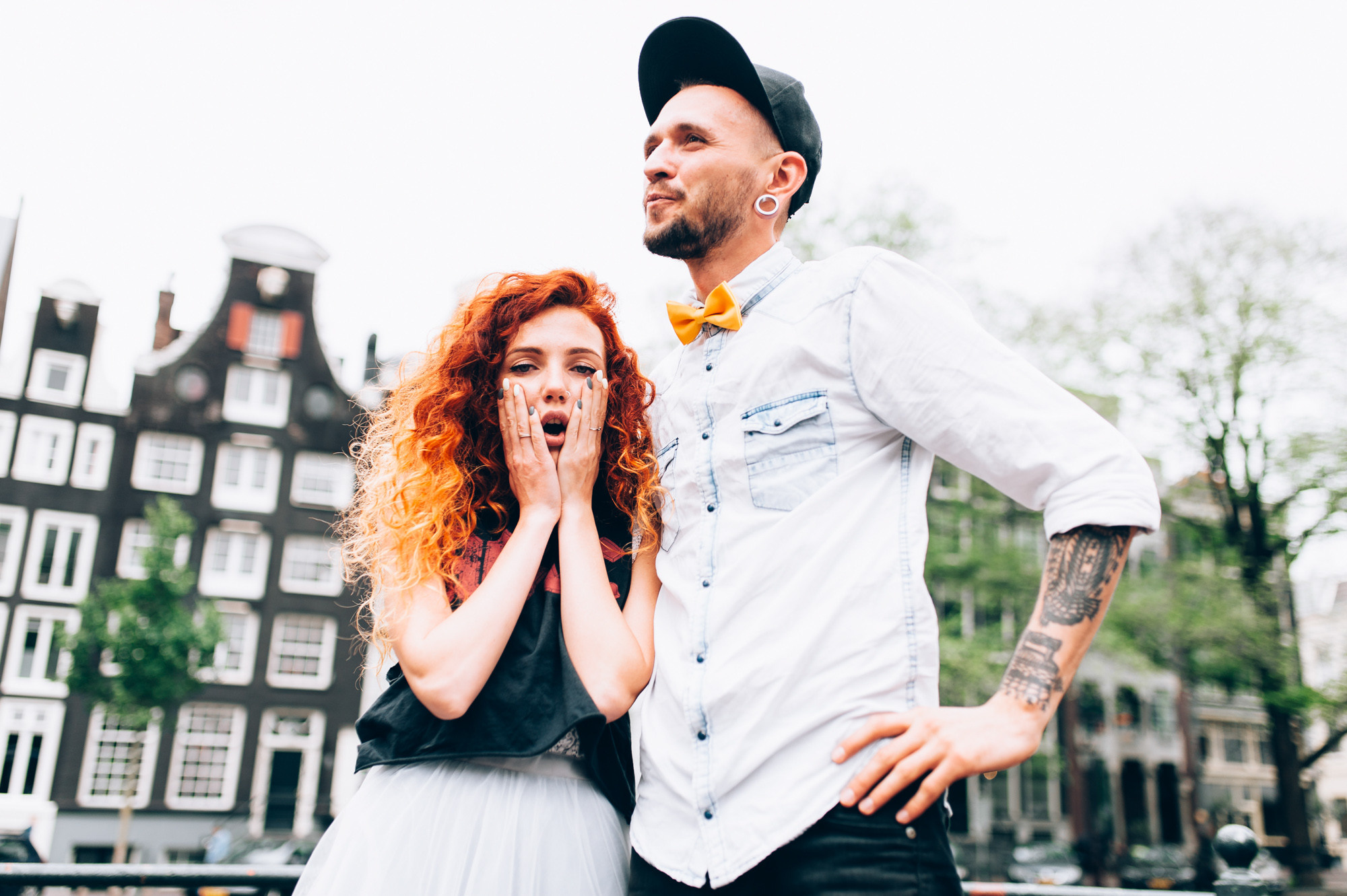 a man and woman standing in front of a building