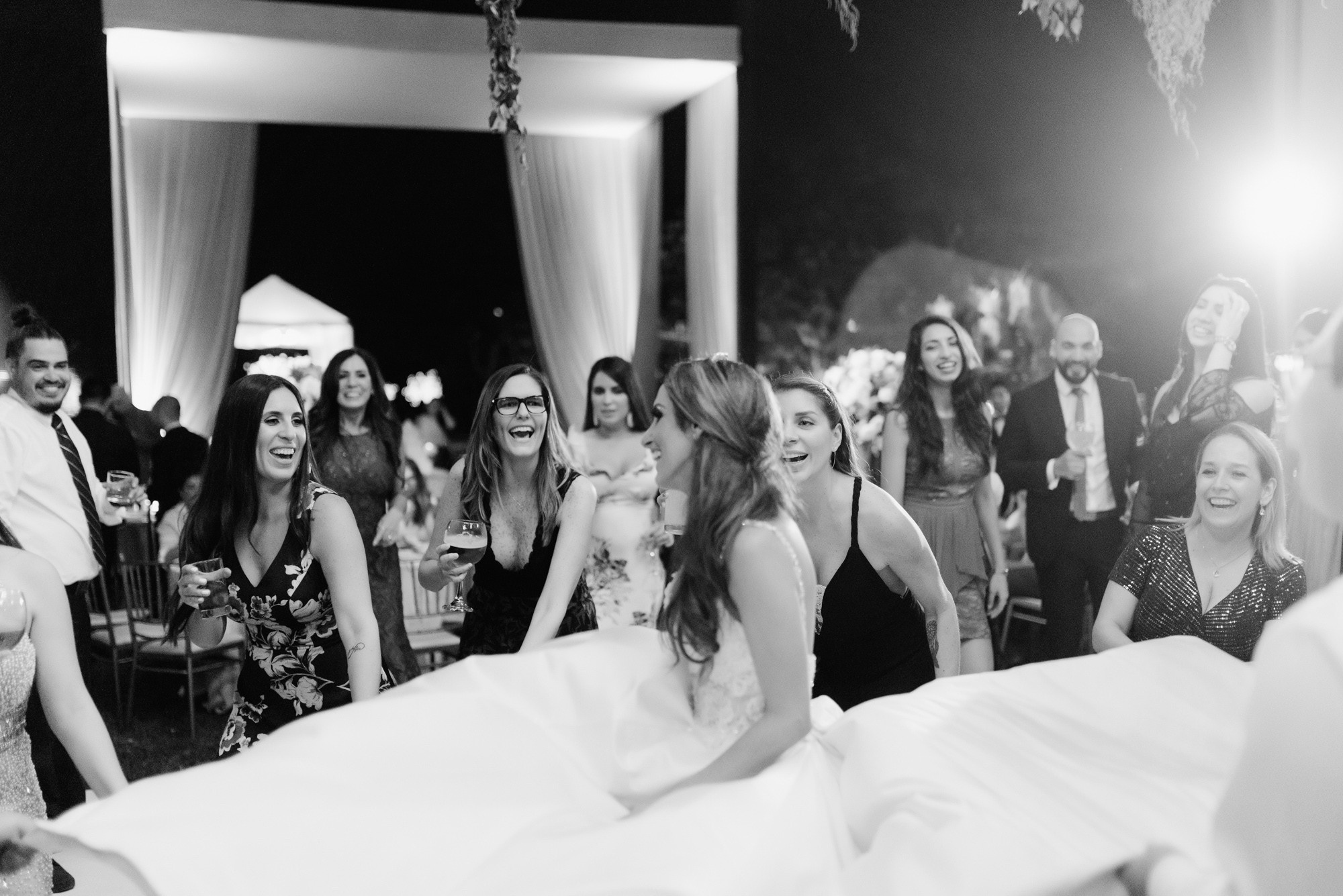 a group of people standing around a bride