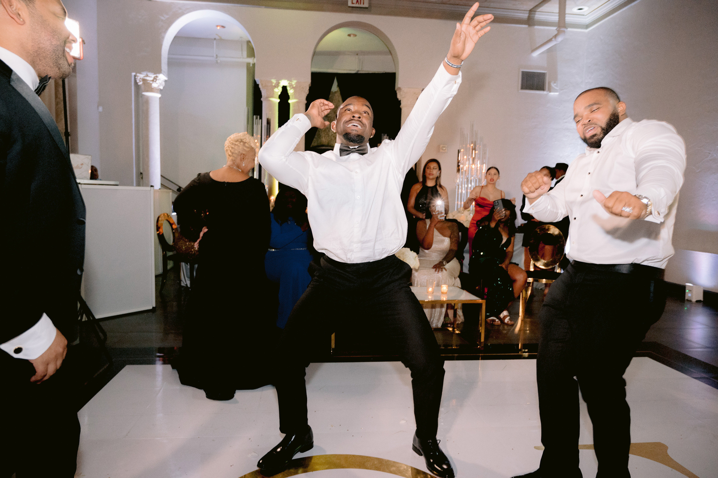 a group of men dancing in a room