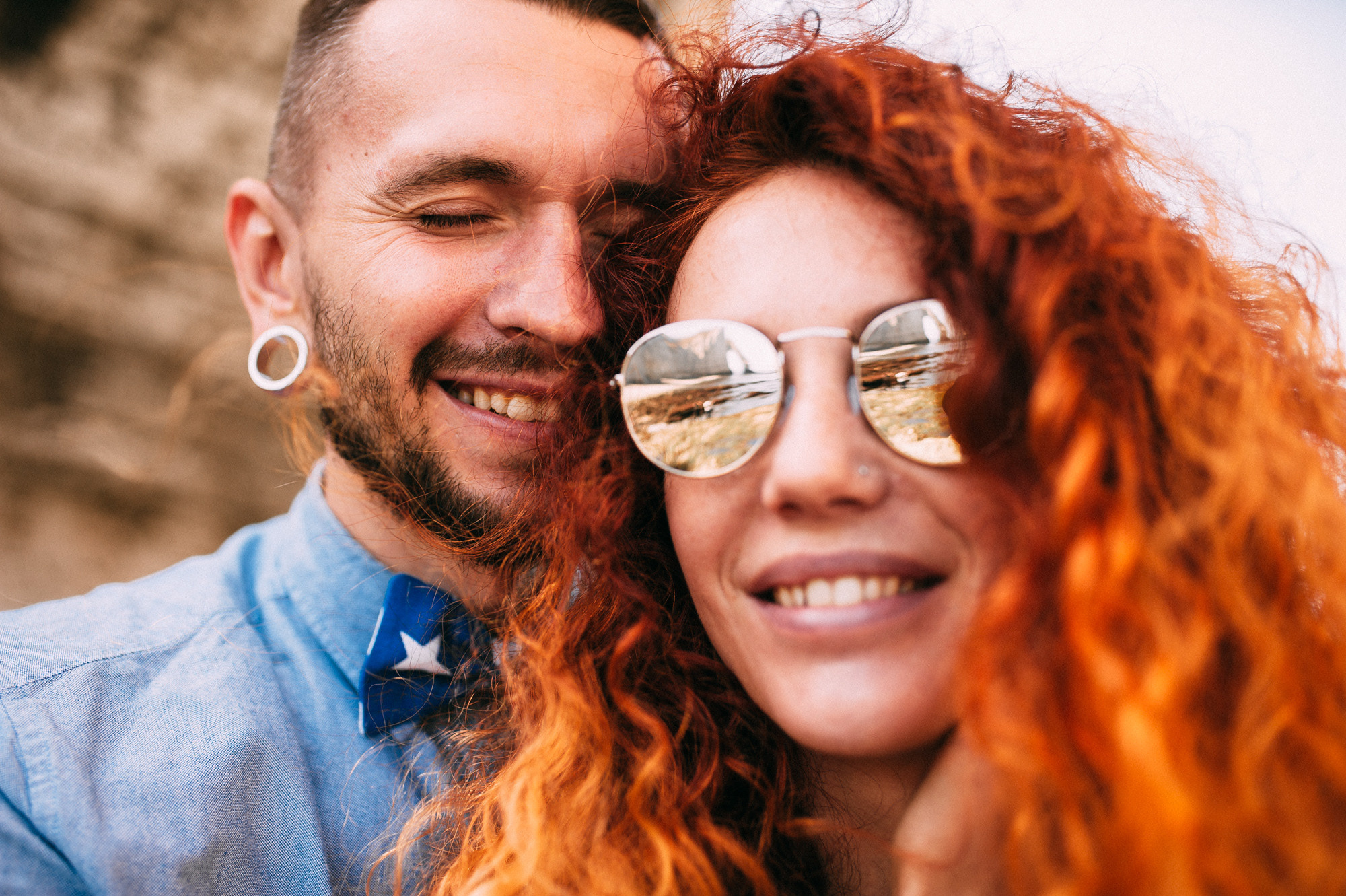 a man and woman with red hair and sunglasses