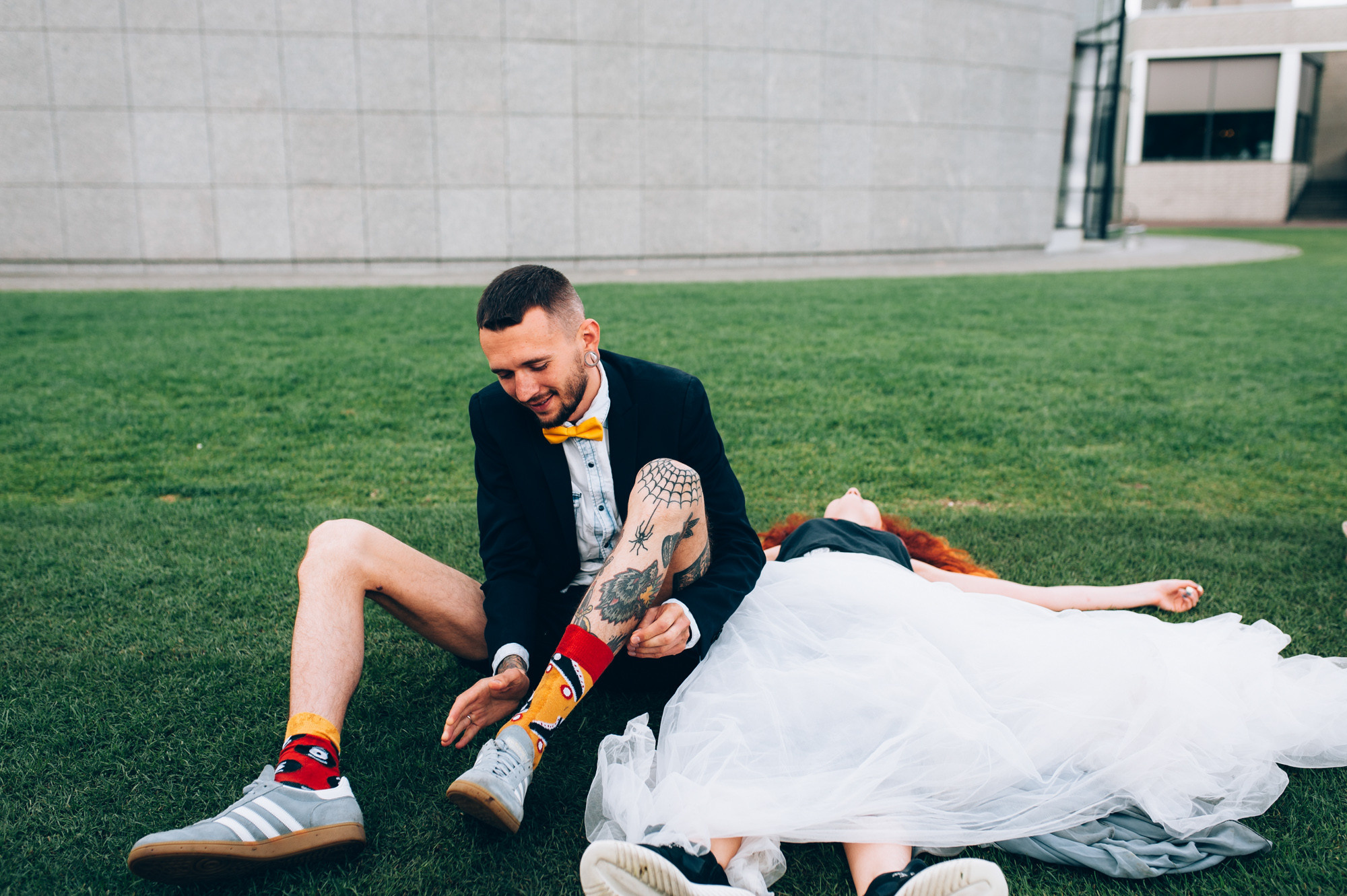 a man and woman laying on the grass