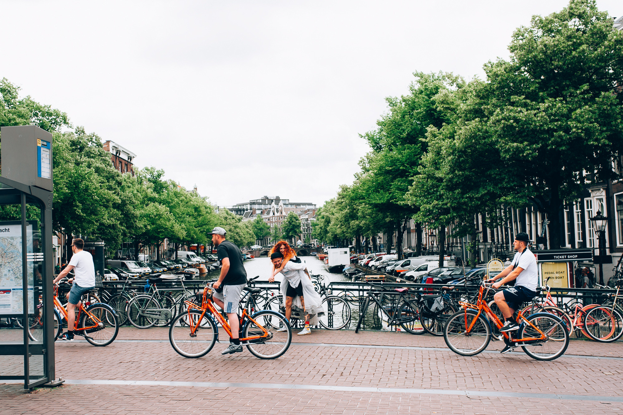 a group of people riding bikes on a city street