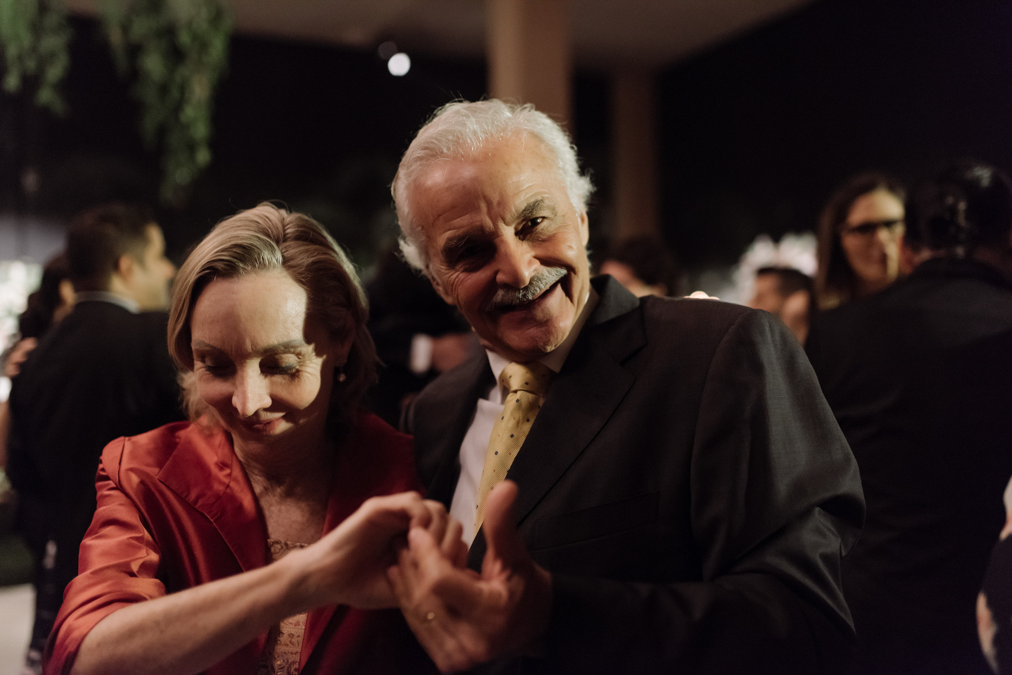 a man and woman dancing together at a party