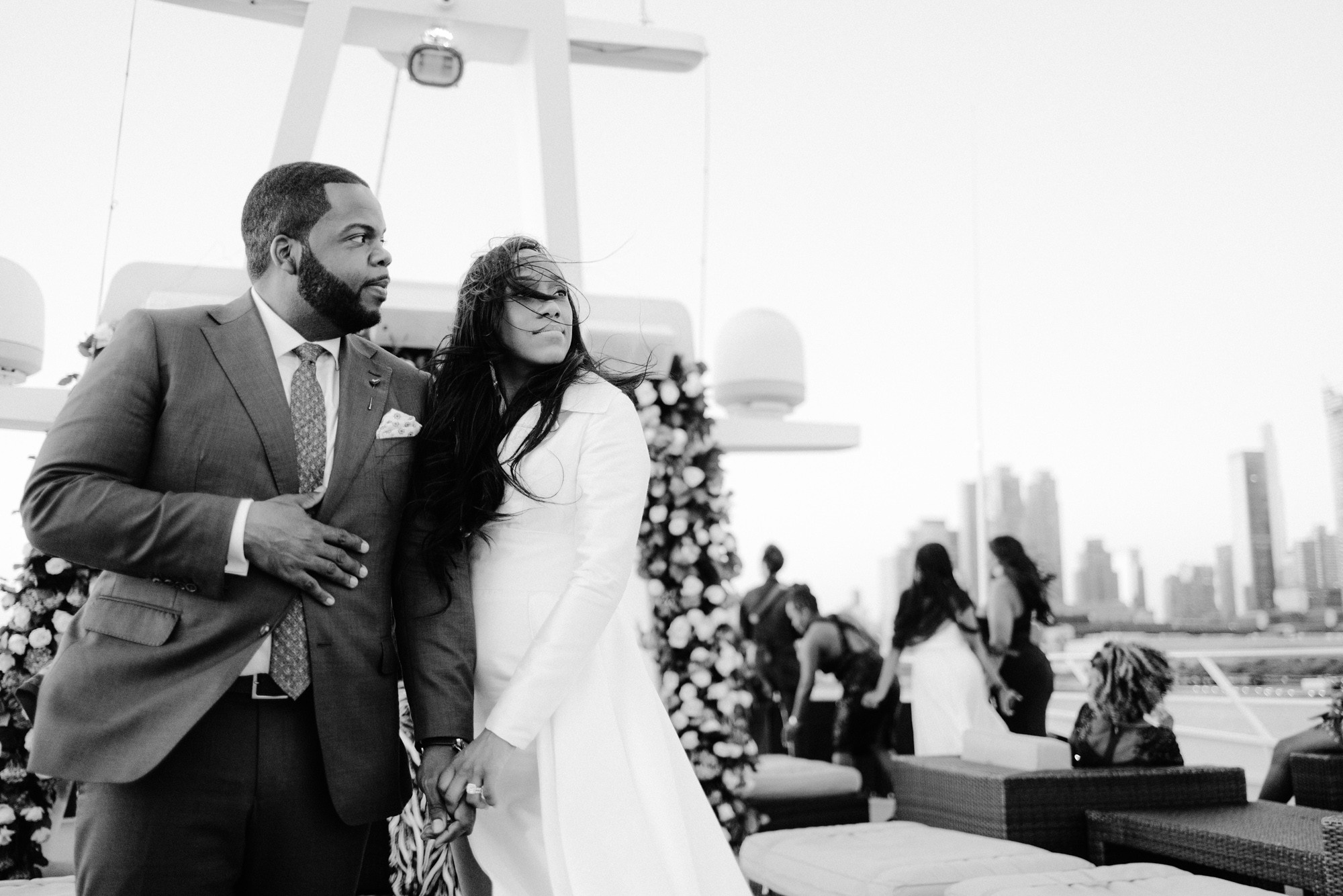 a bride and groom pose for a photo on the rooftop of their wedding