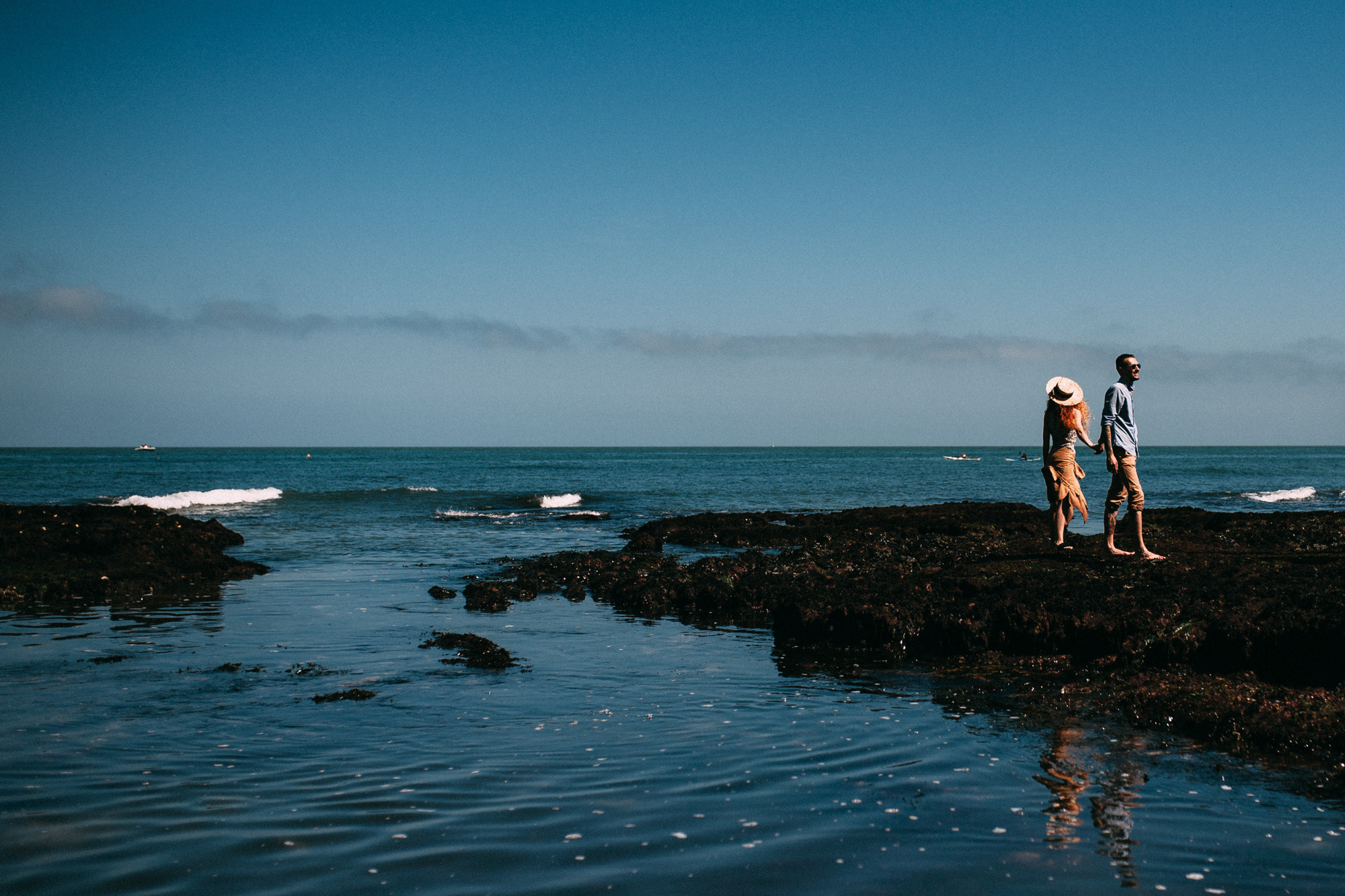 a man standing on a rock in the ocean