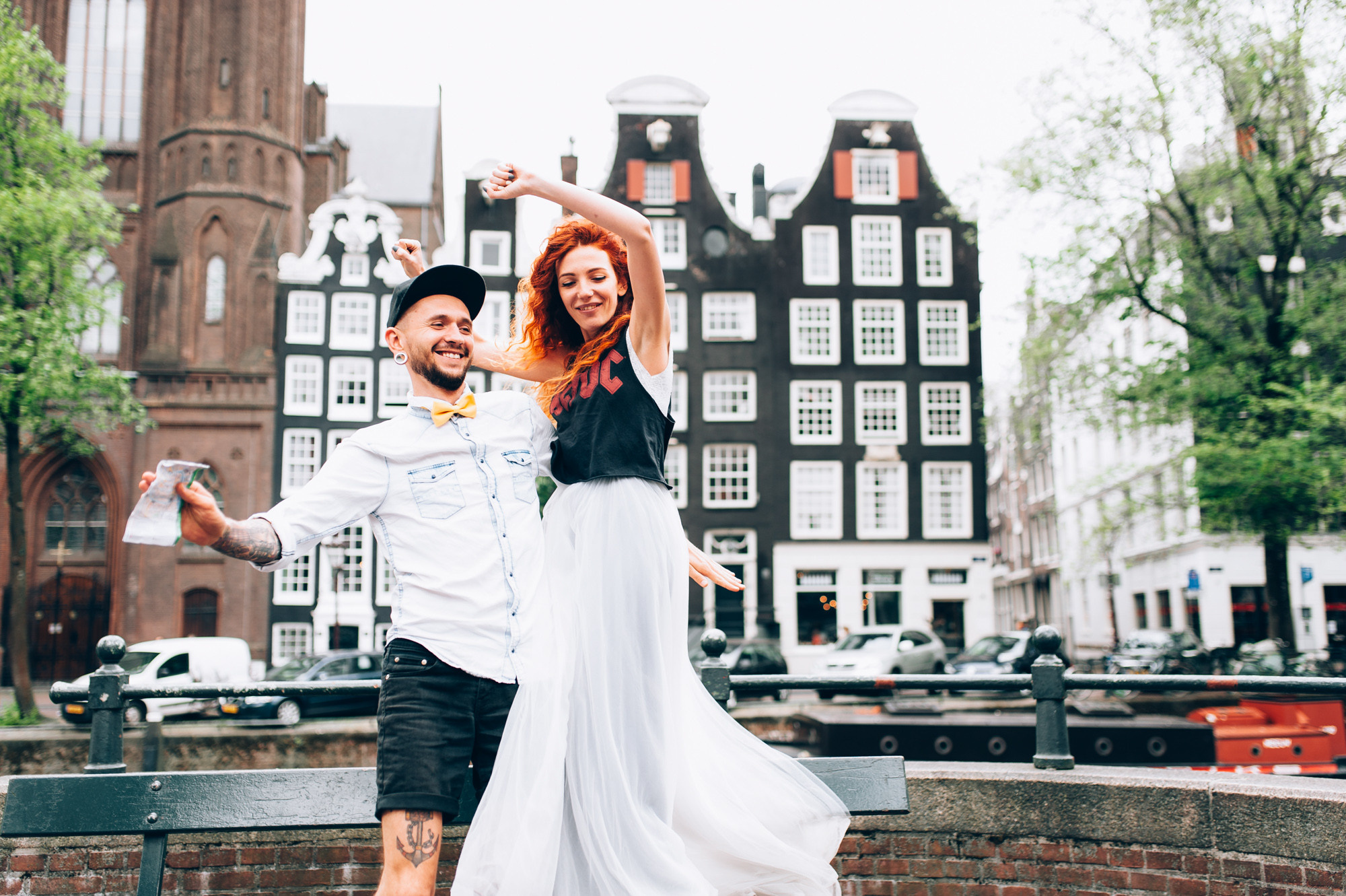 a man and woman dancing in front of a building