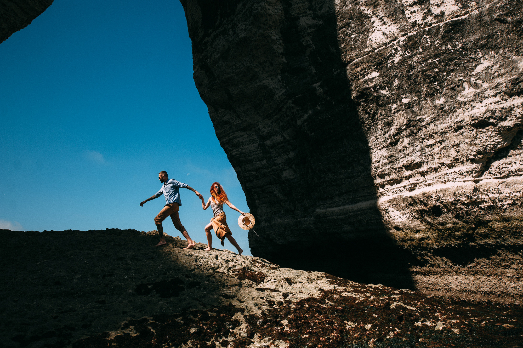 a couple is walking through a cave