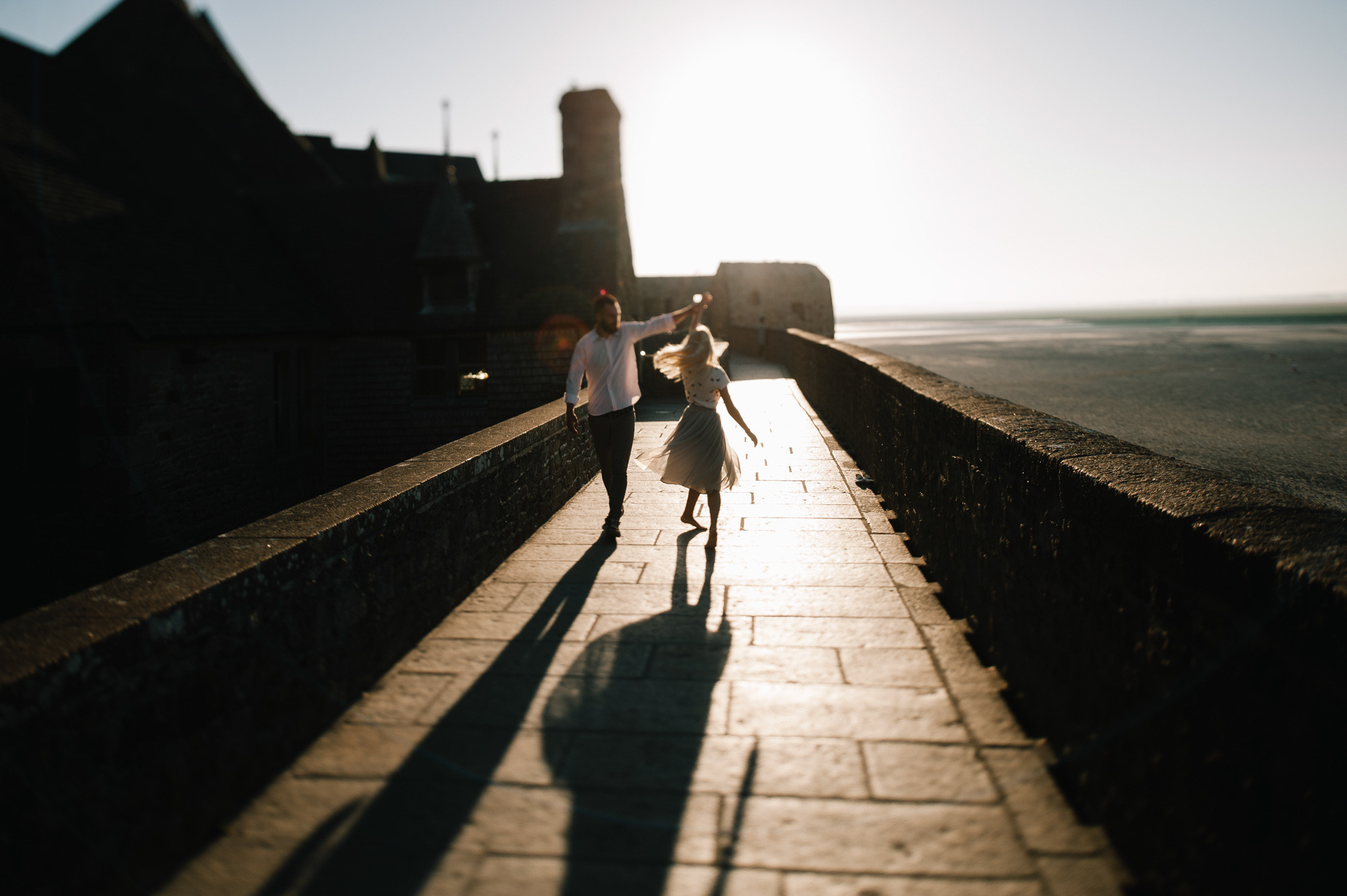 a person is walking on a brick wall