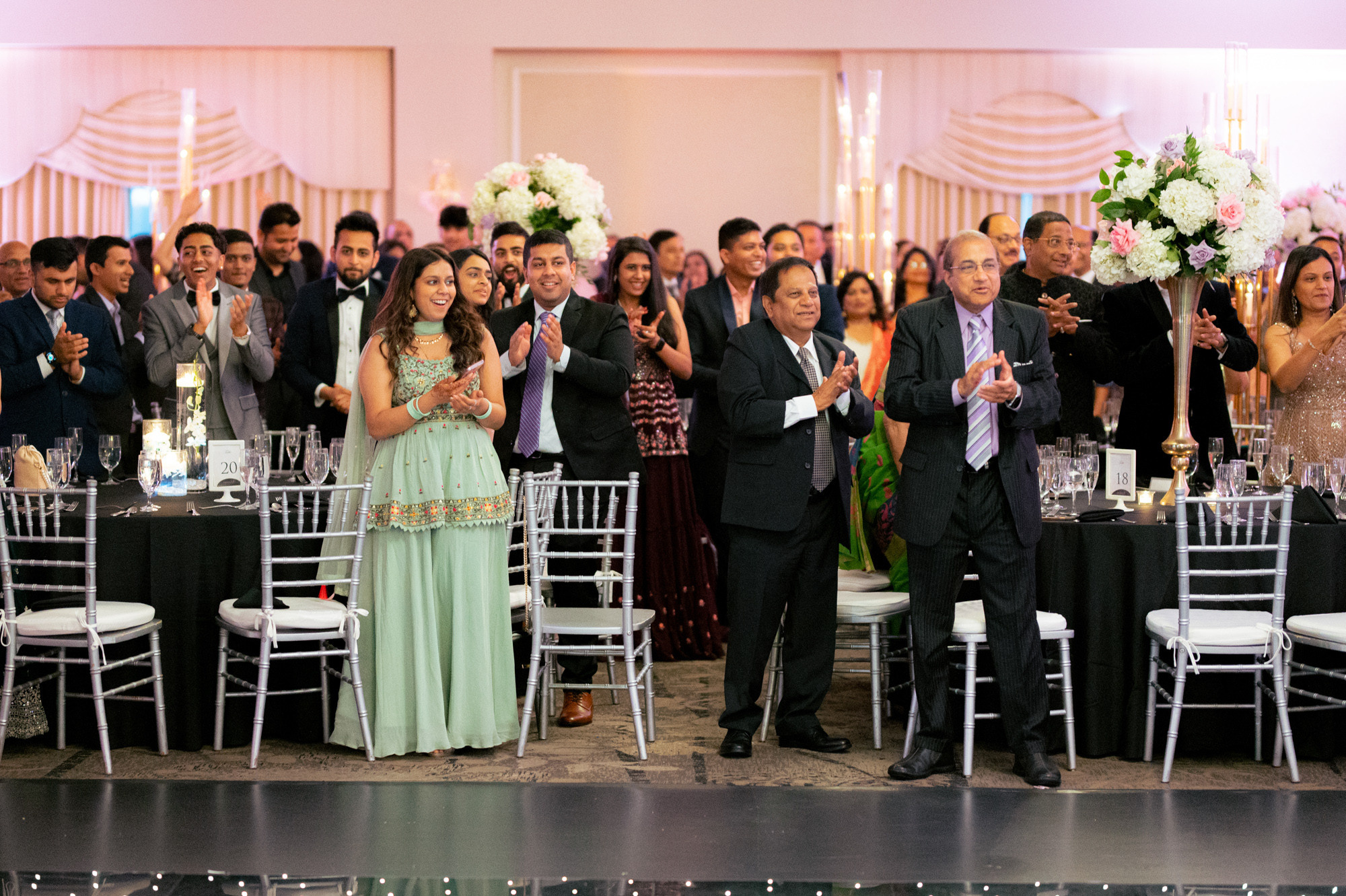 a group of people standing around a table