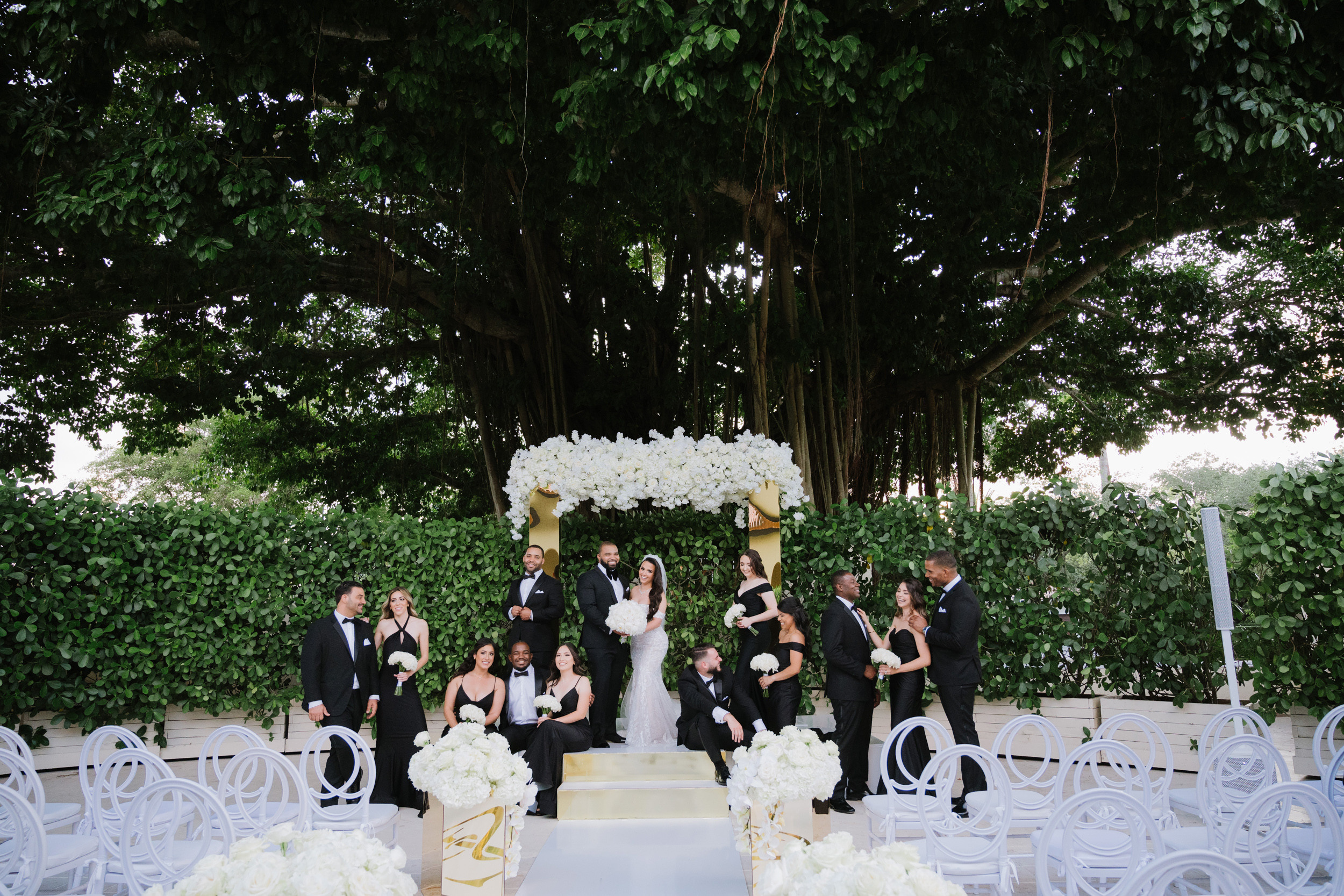 a wedding party with a white table and chairs