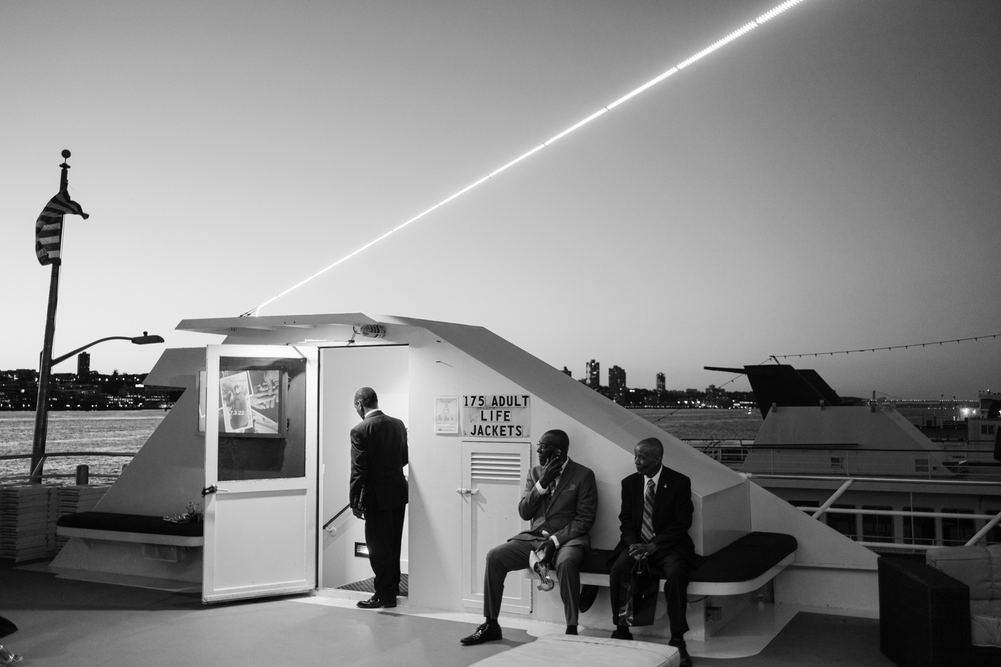 a couple of people sitting on a bench on a boat