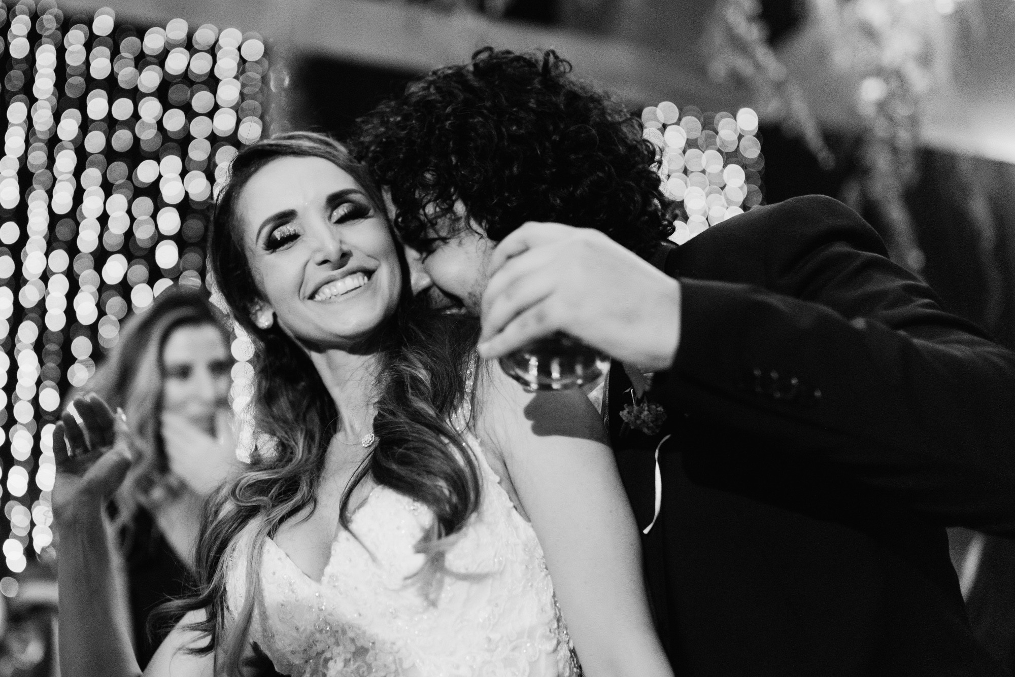 a bride and groom sharing a kiss at their wedding reception