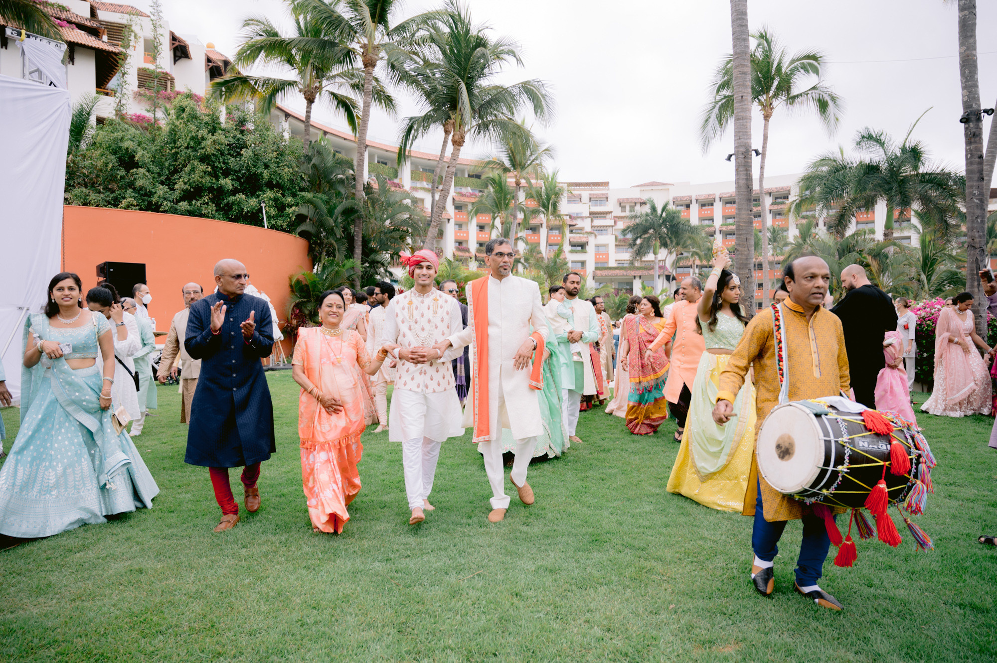 a group of people walking through a lush green field