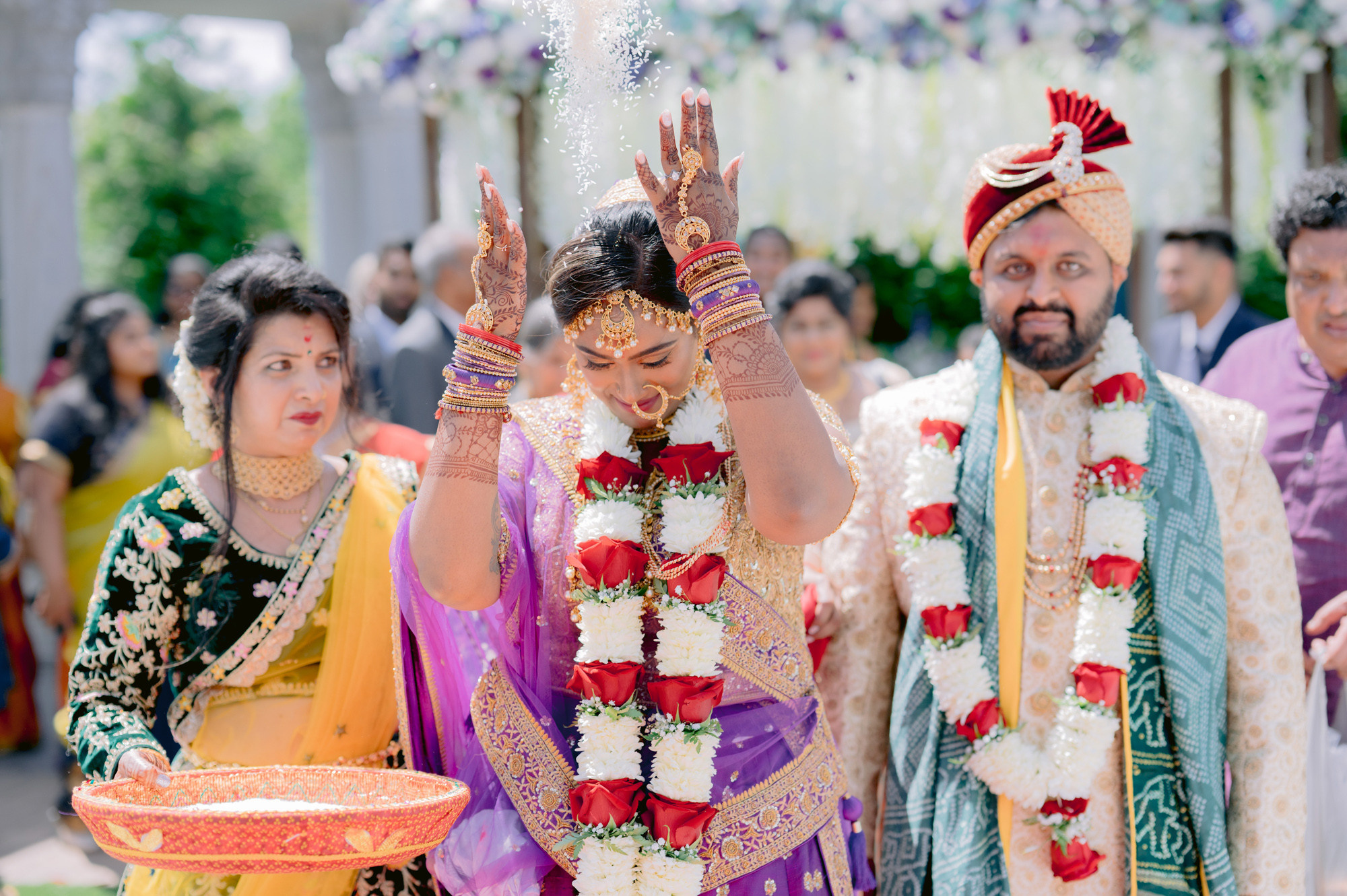 a bride and groom are showered with water during their hindu ceremony