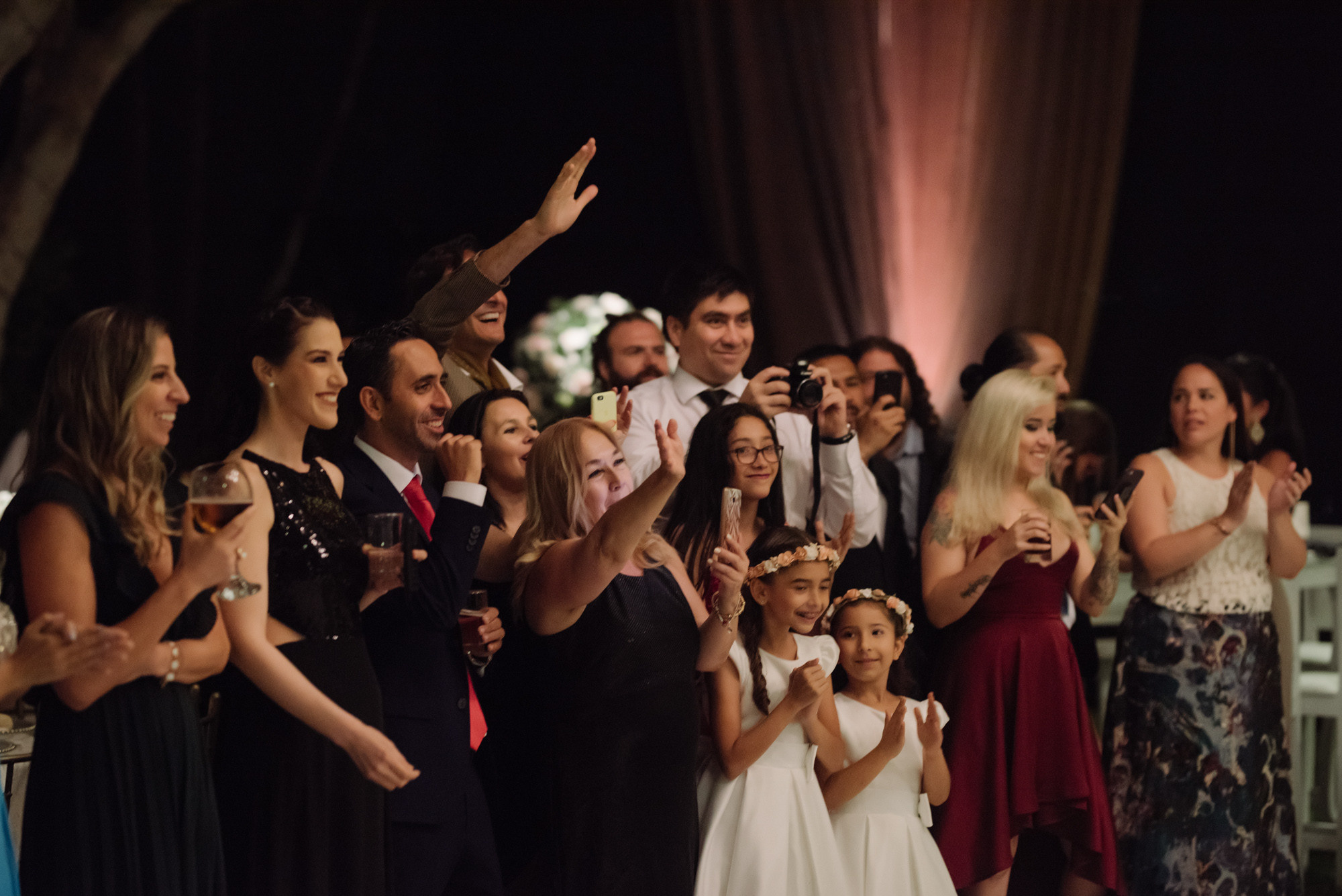 a group of people standing around a cake