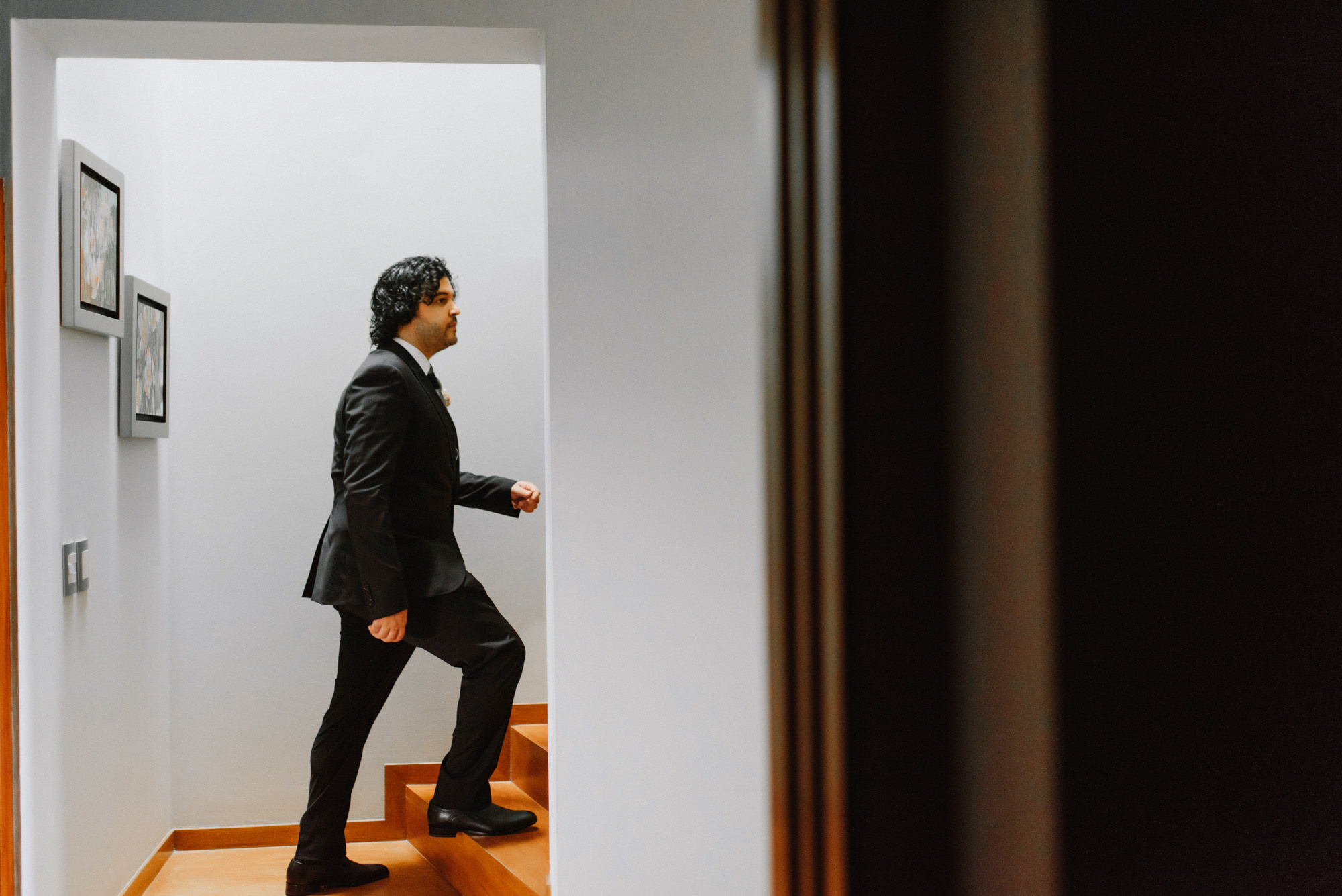 a man in a suit is walking up a flight of stairs