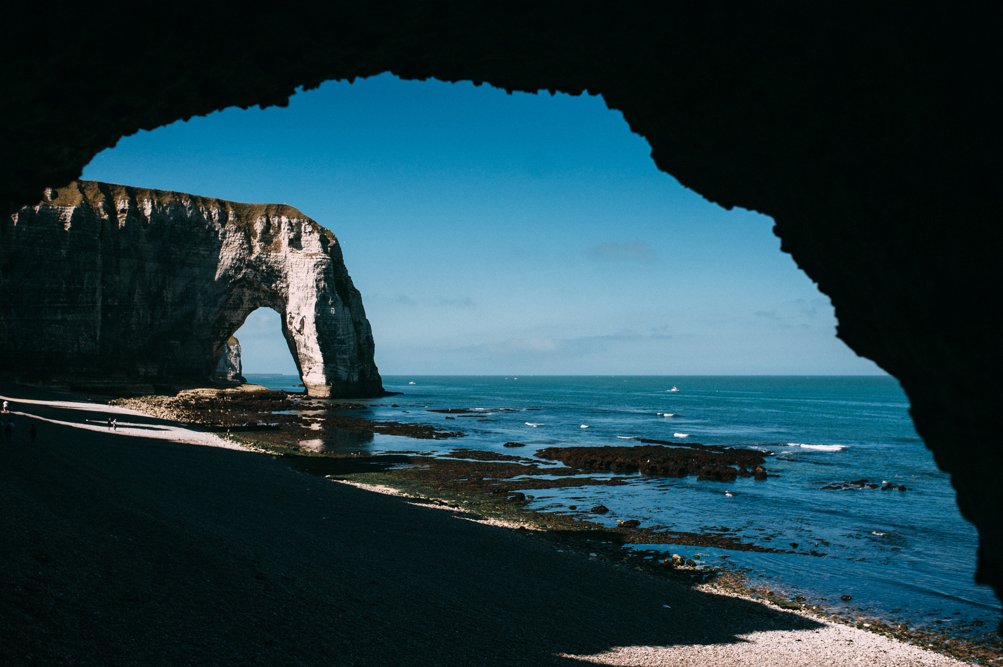 a view of a rocky beach with a large rock formation