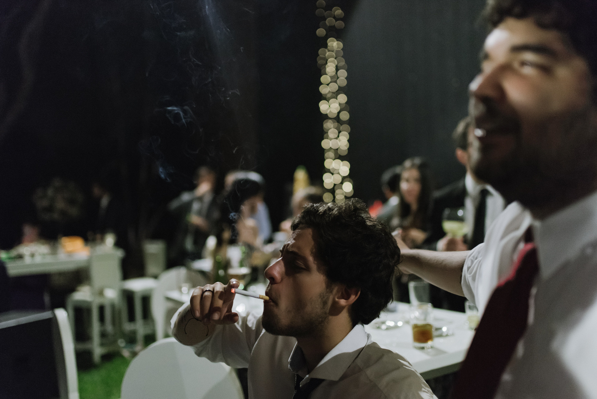 a man smoking a cigarette in a restaurant