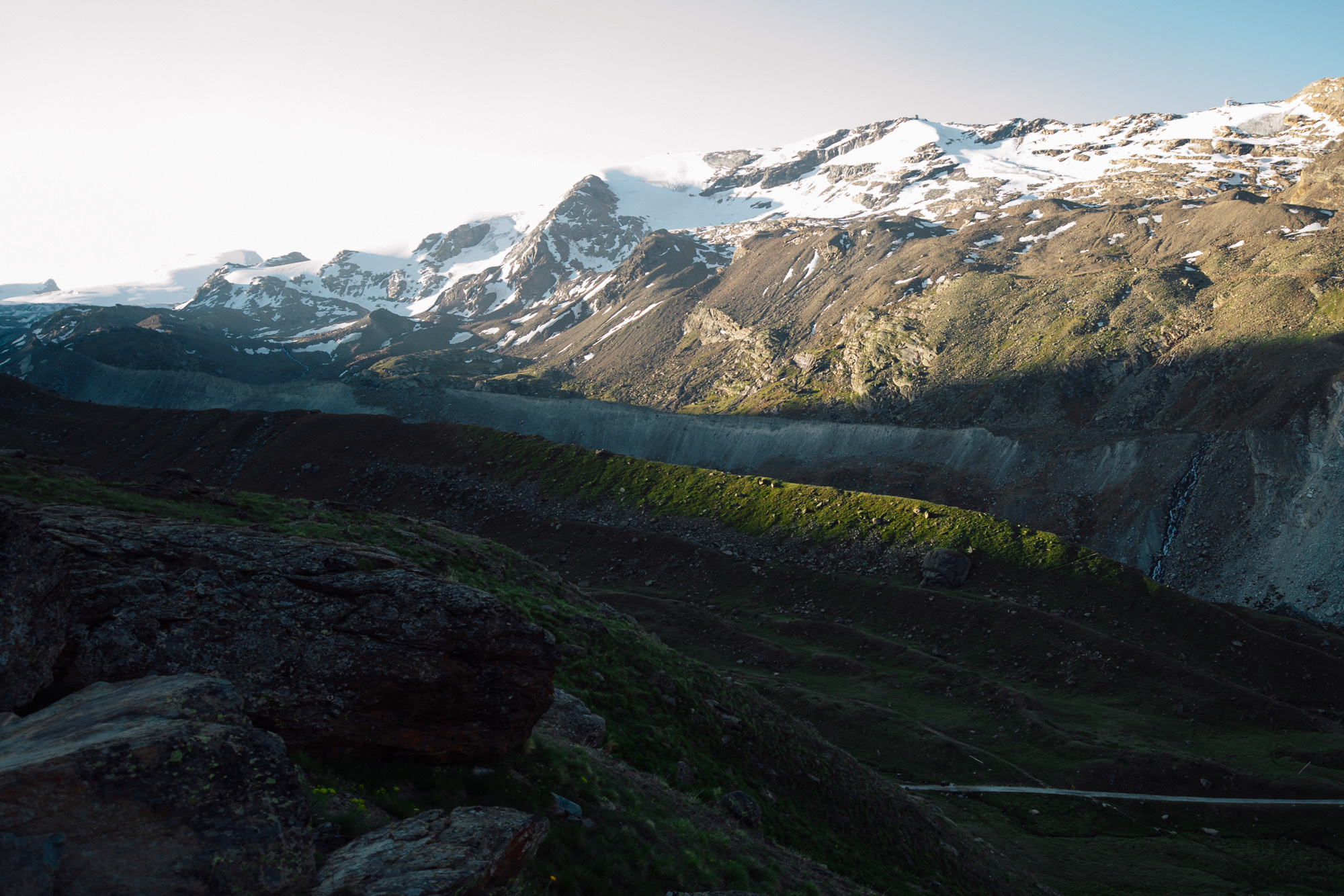 a mountain with a large rock in the fore
