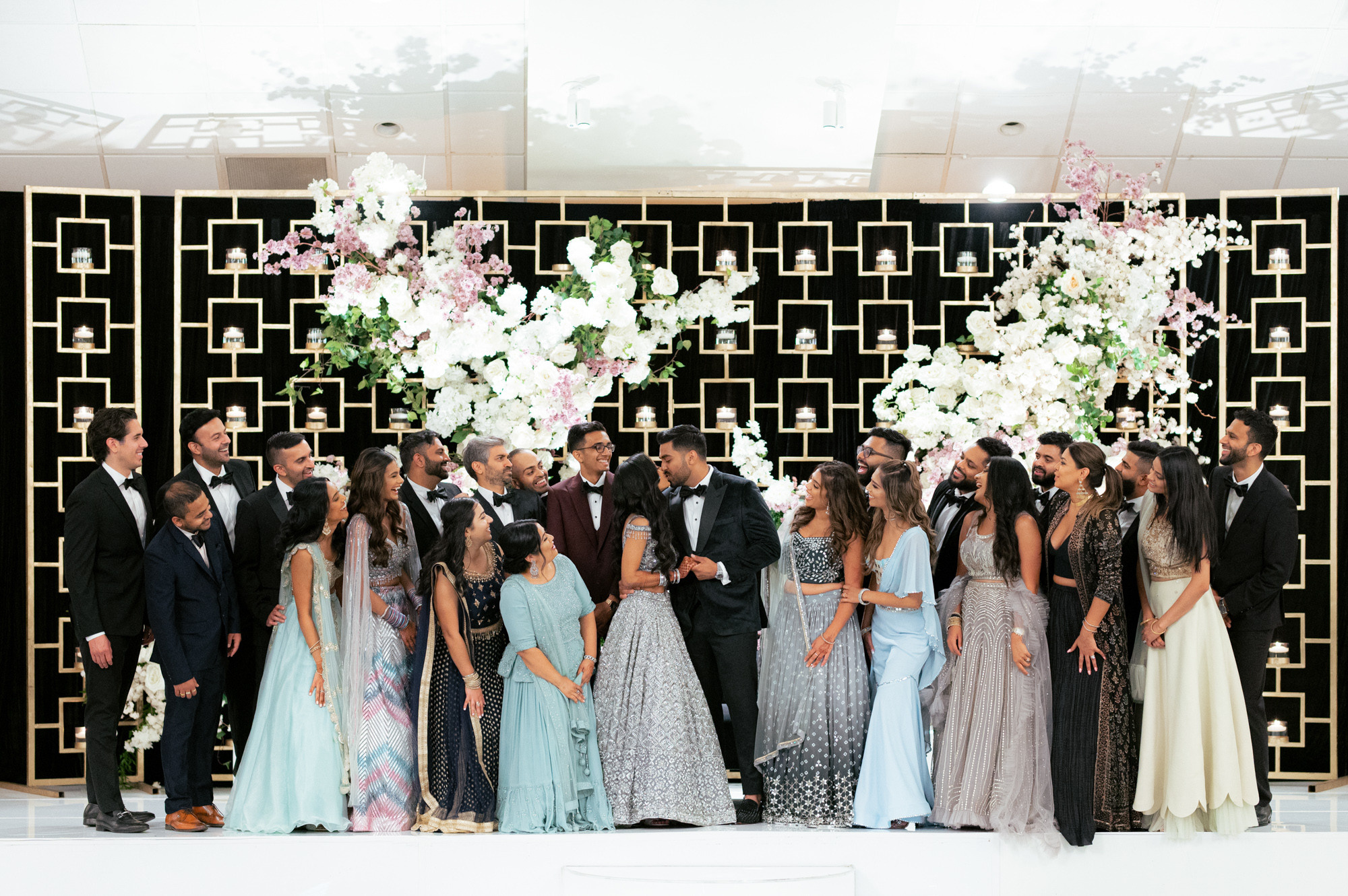 a group of people standing in front of a black and white wall