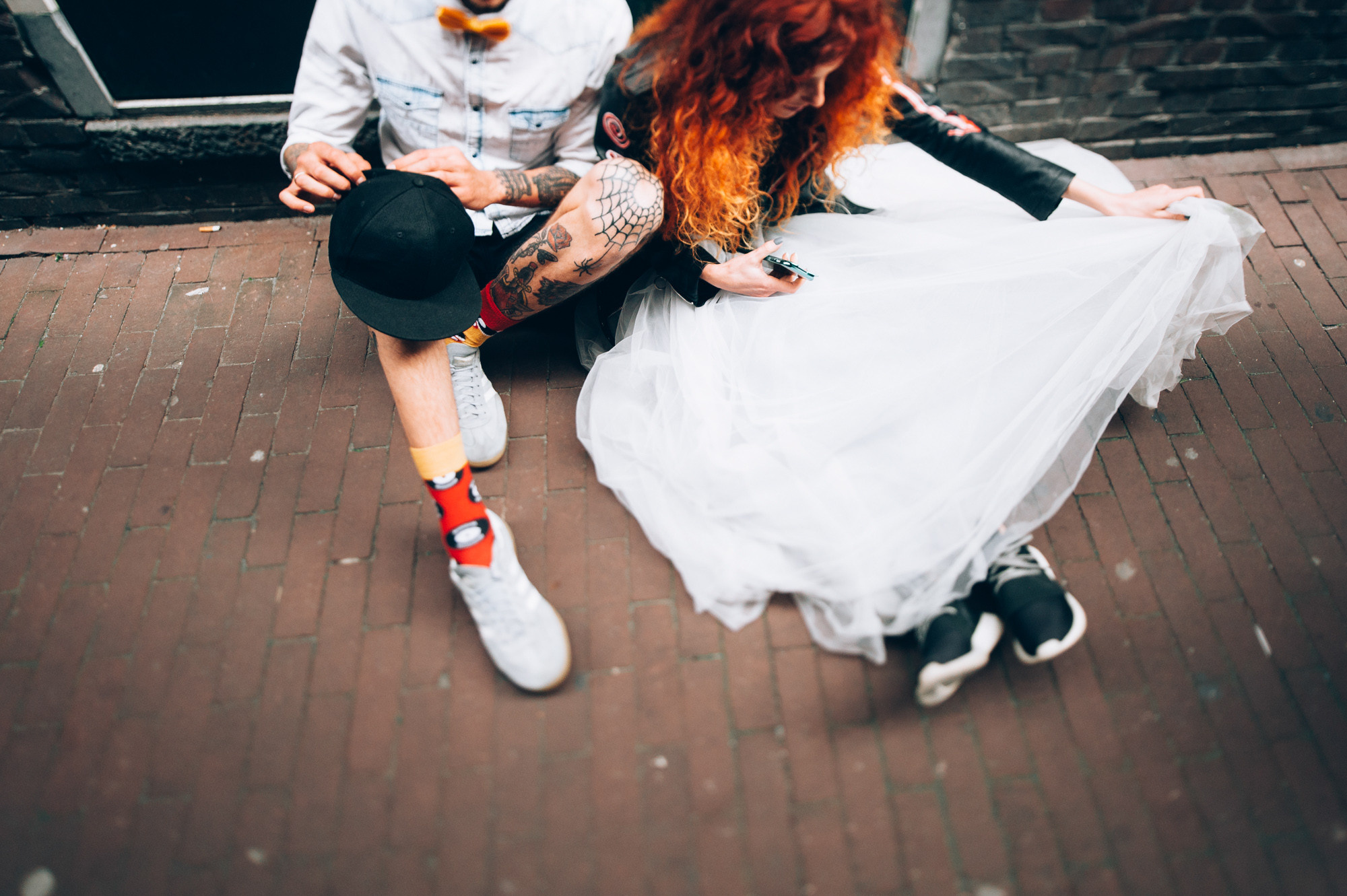 a man and woman sitting on the ground