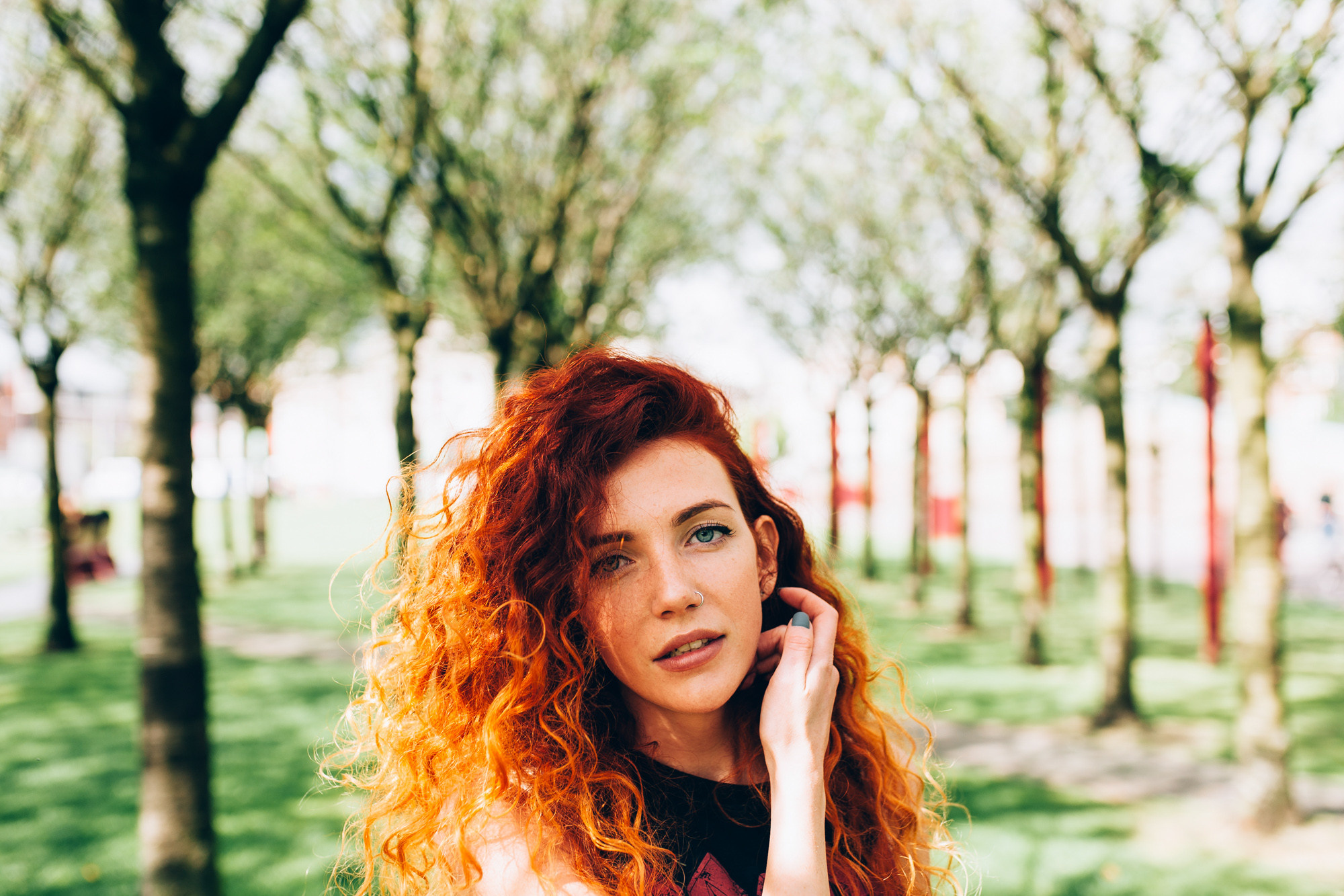 a woman with red hair talking on a cell