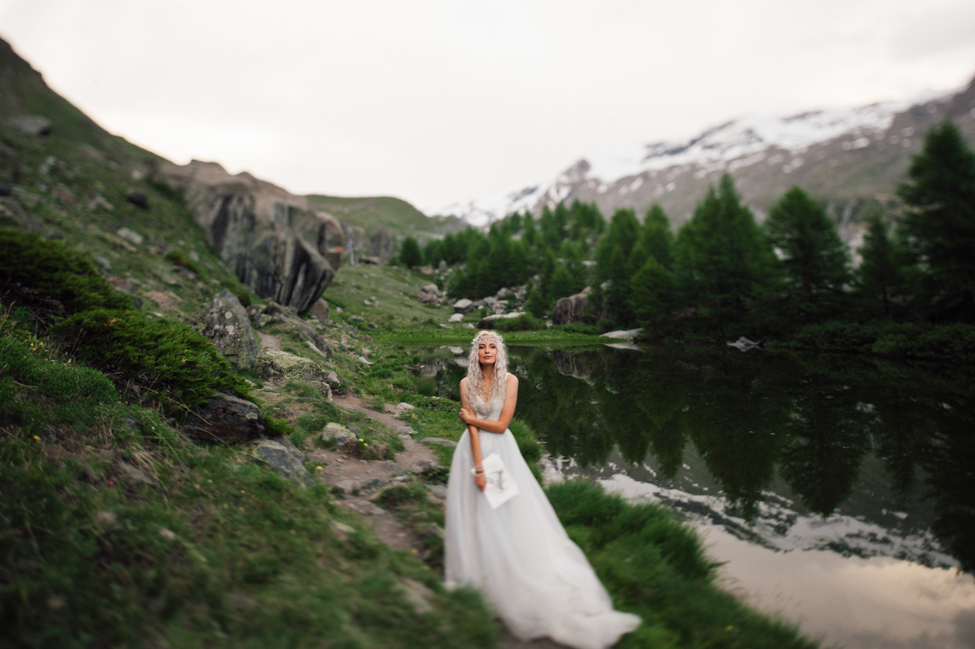 a bride standing on a mountain side
