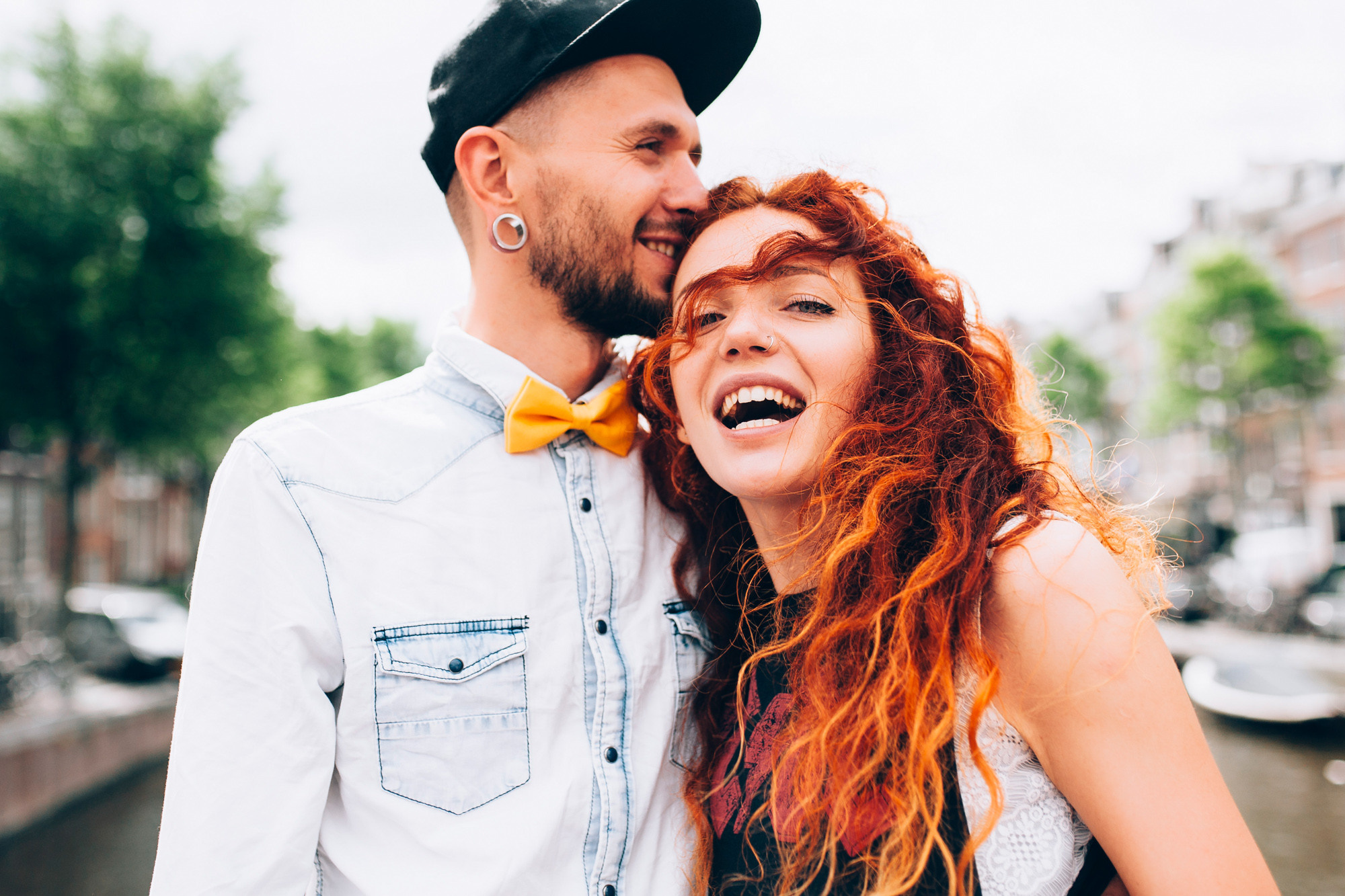a man and woman are smiling and hugging