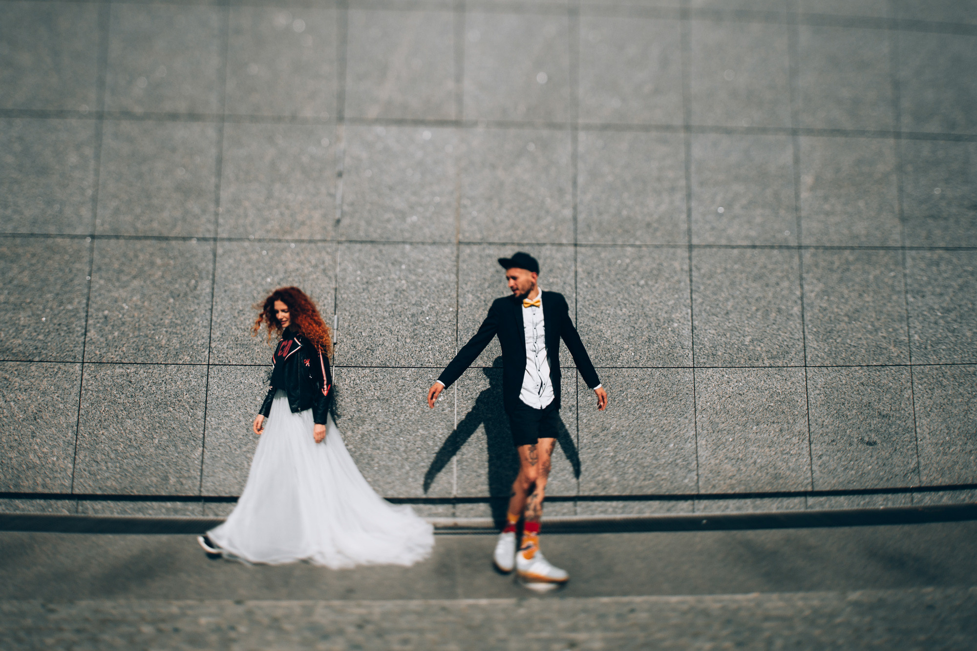 a couple walking down a street holding hands