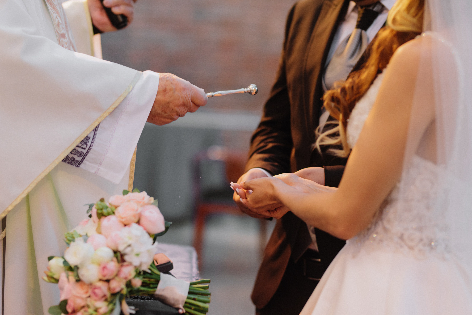 a bride and groom are exchanging their wedding rings