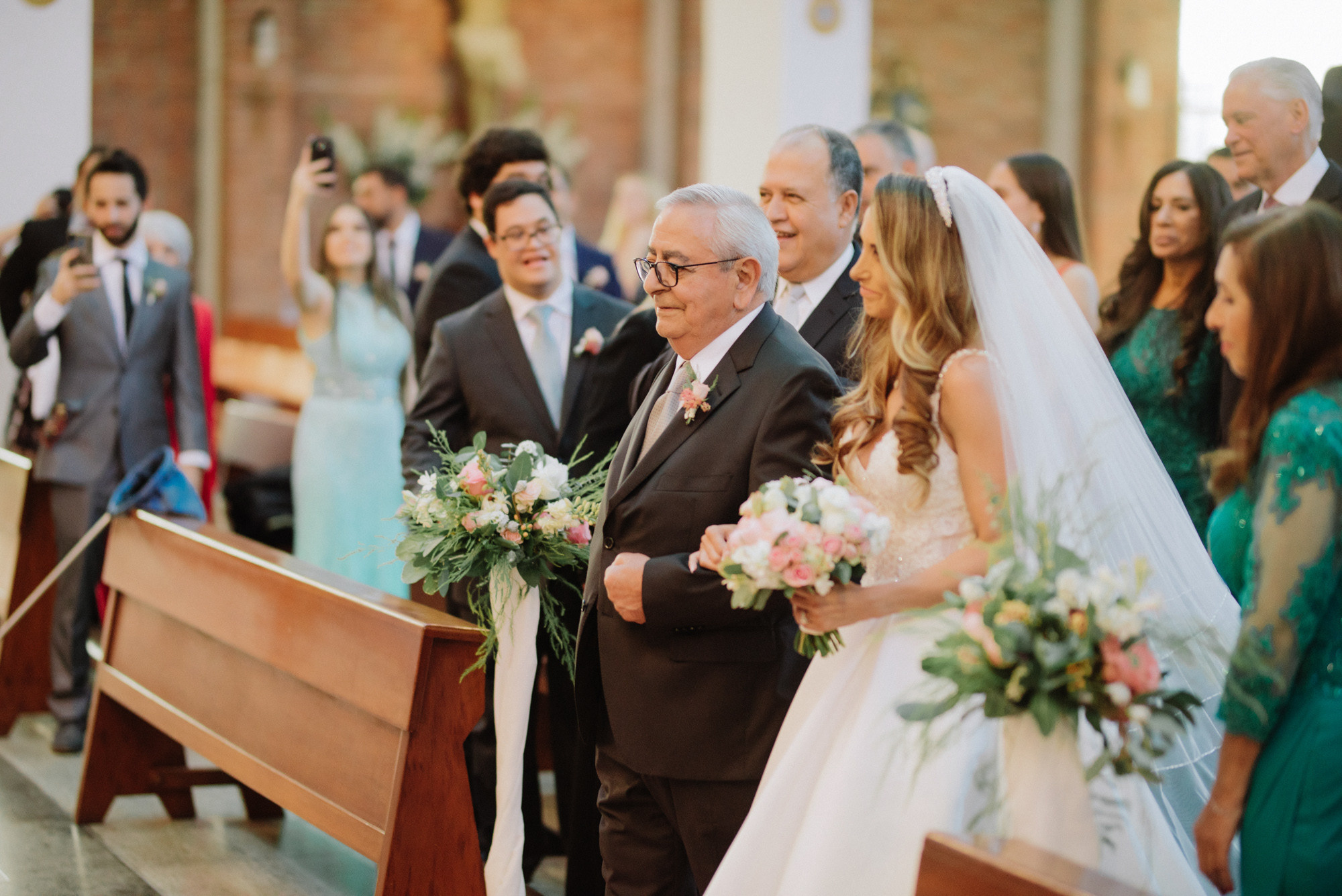 a bride and her father walking down the aisle