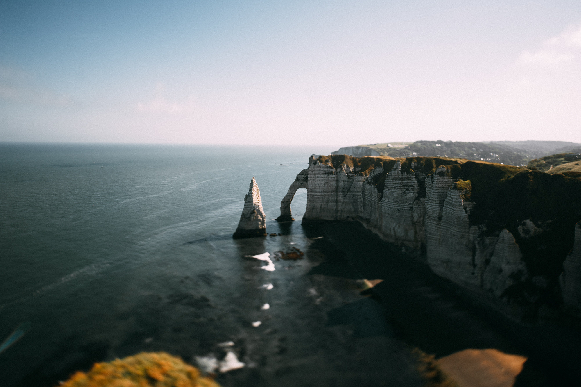 a view of a cliff with a boat in the water