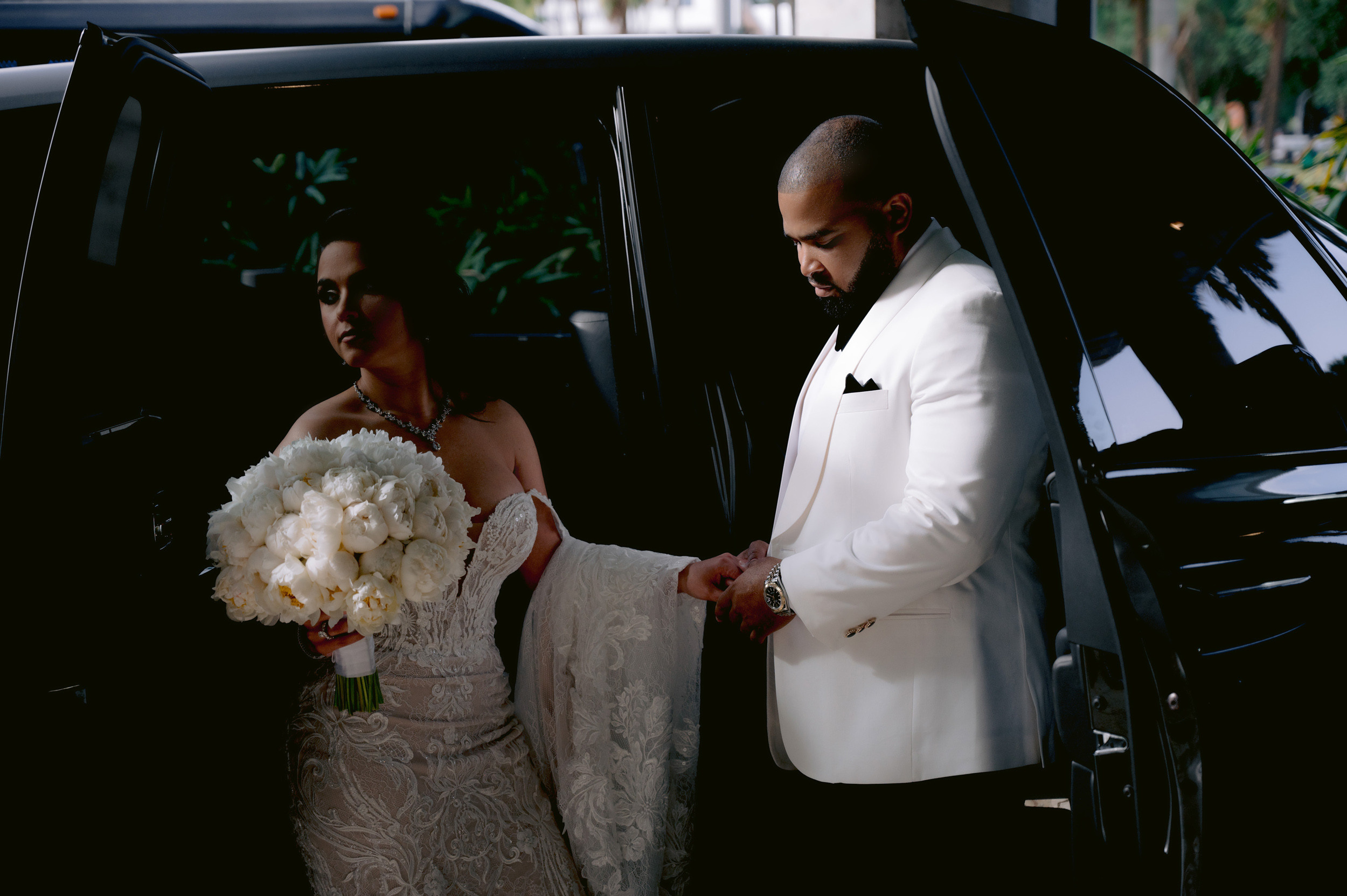 a bride getting into a limo