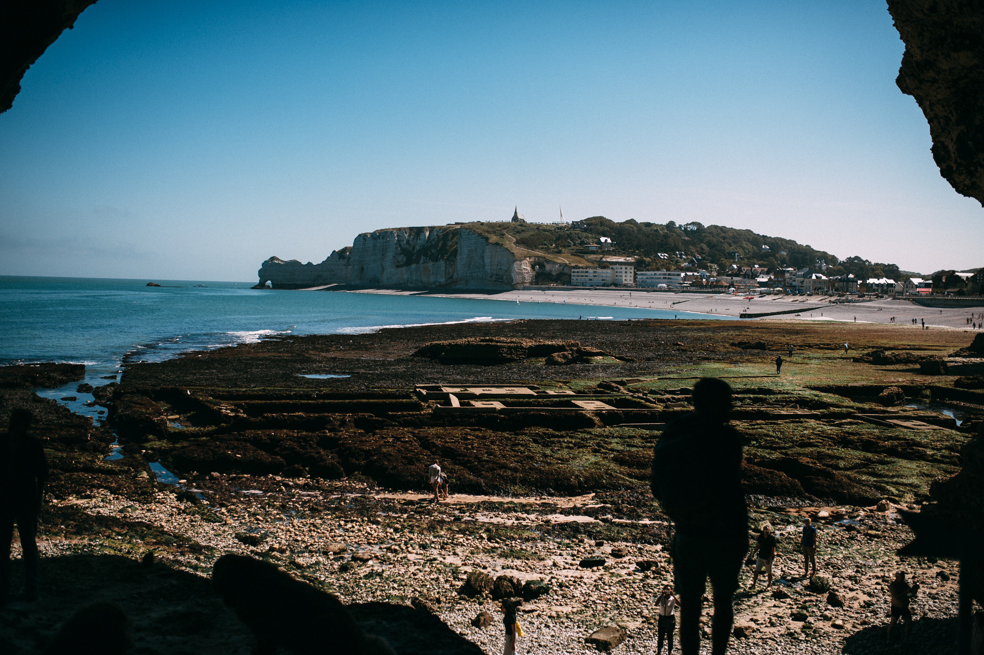 a group of people standing on a rocky beach