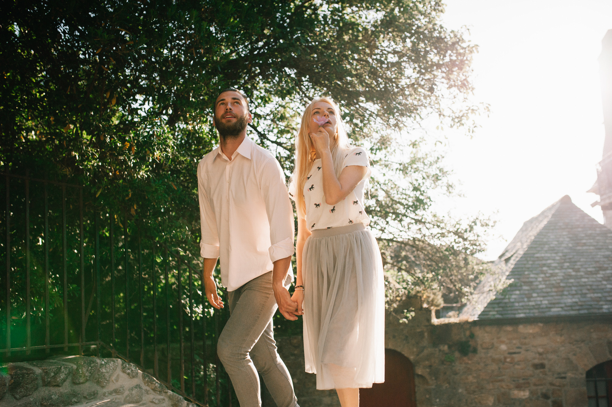 a man and woman are standing on a skateboard