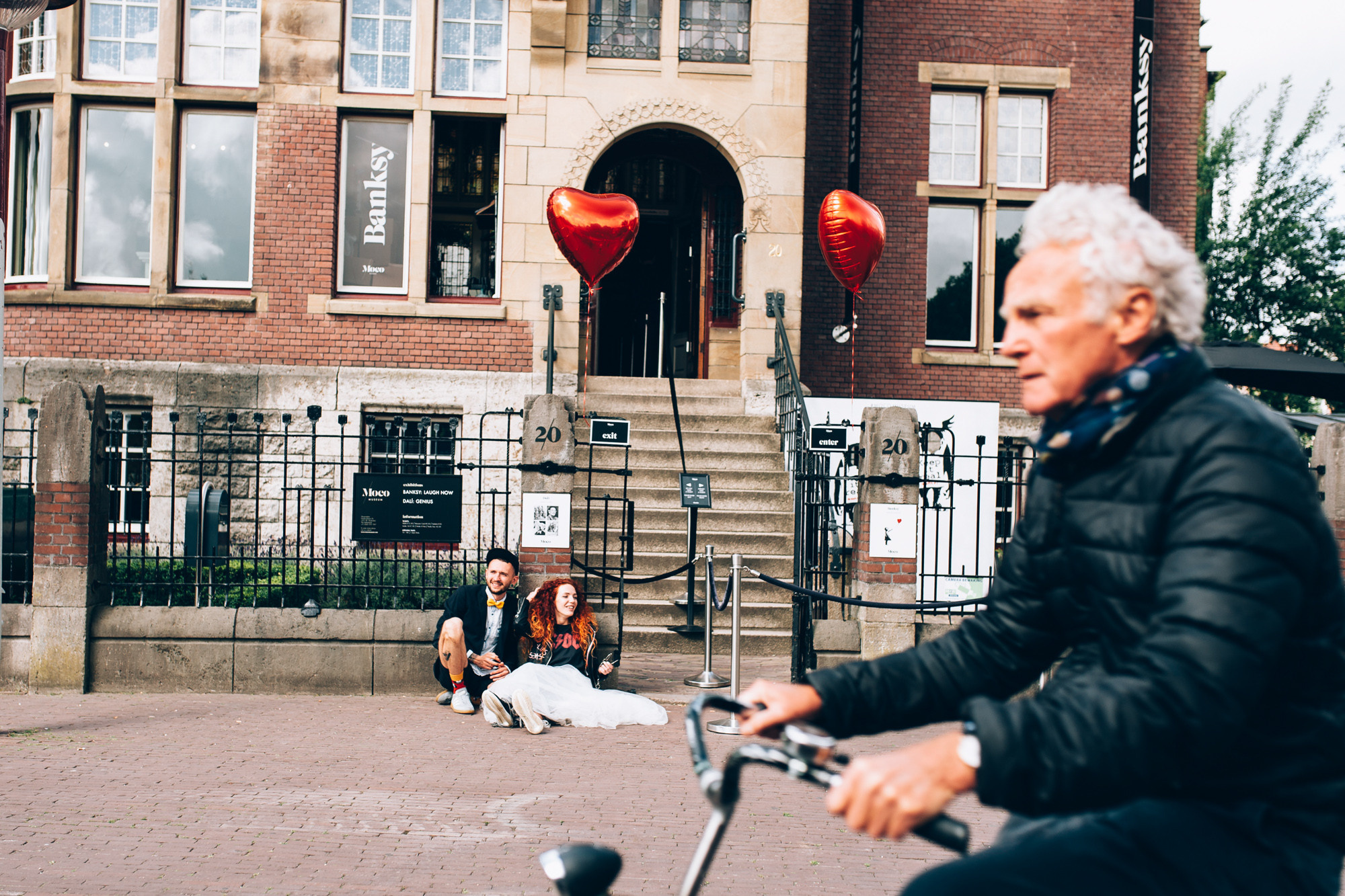 a man riding a scooter on a sidewalk