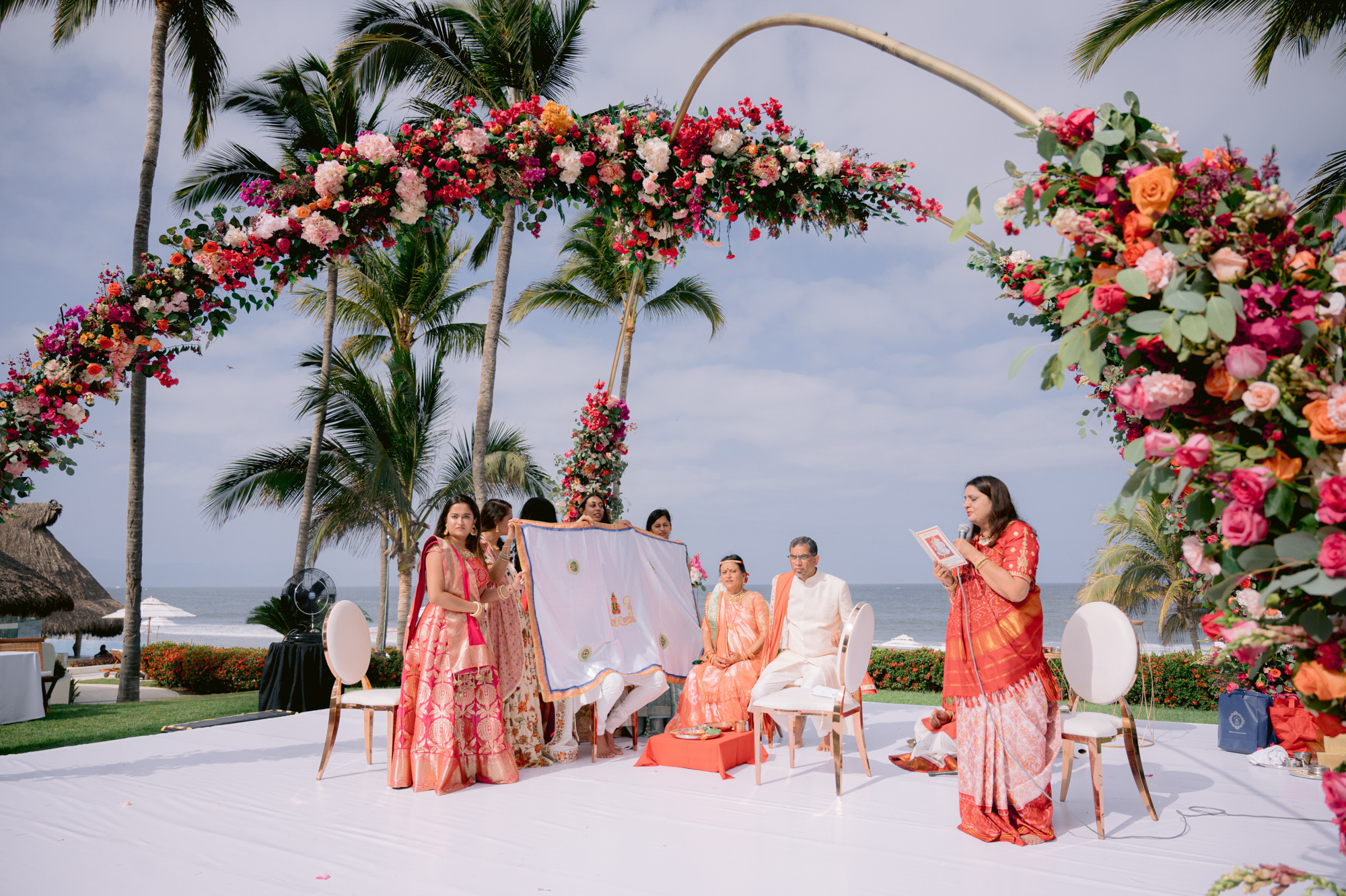 a couple sitting on a white table with flowers
