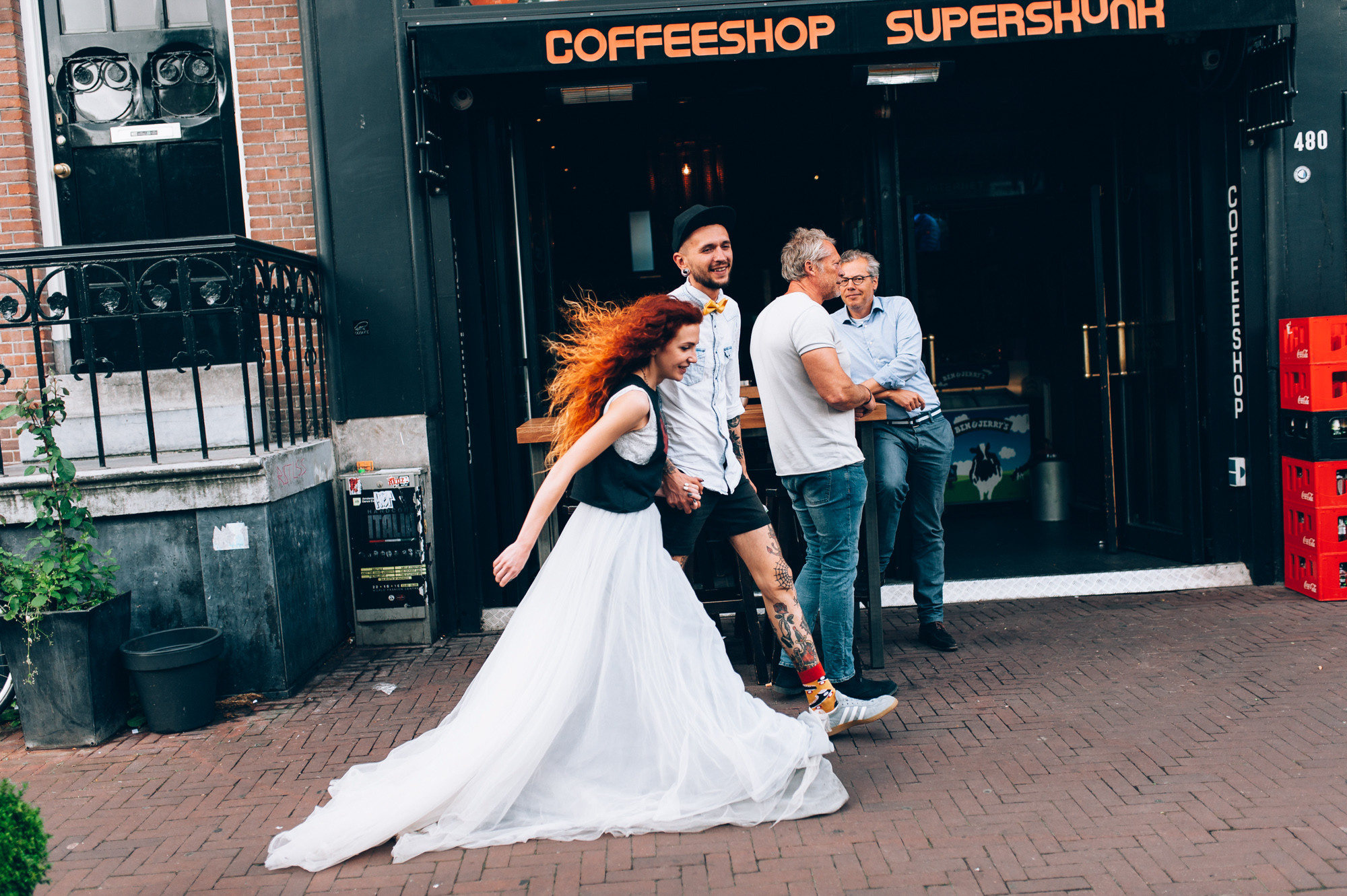 a man and woman walking down a brick sidewalk