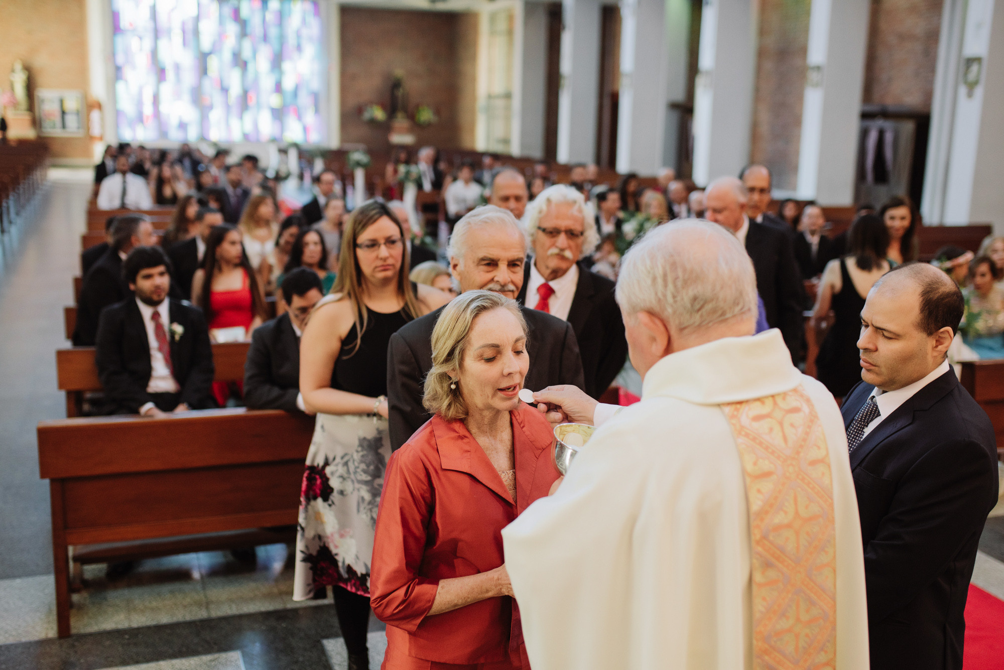 a woman is putting a ring on a man's finger