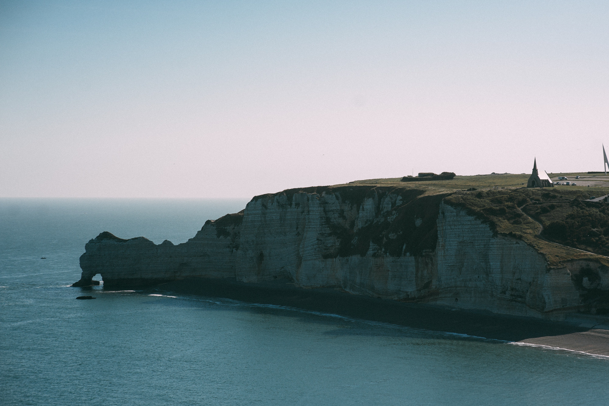 a large cliff on the ocean