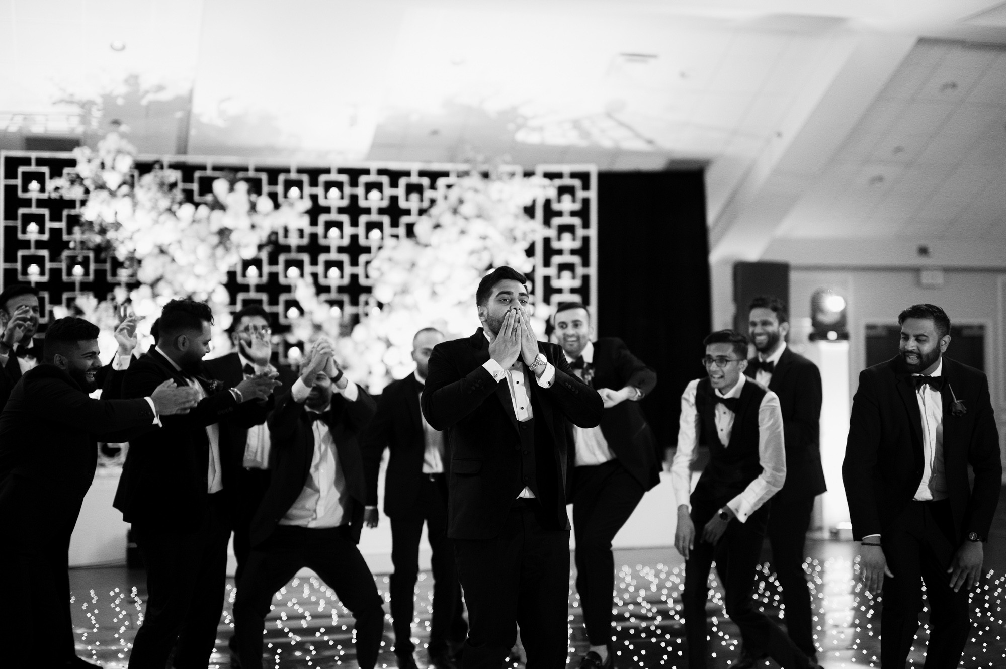 a group of men in suits and ties dancing