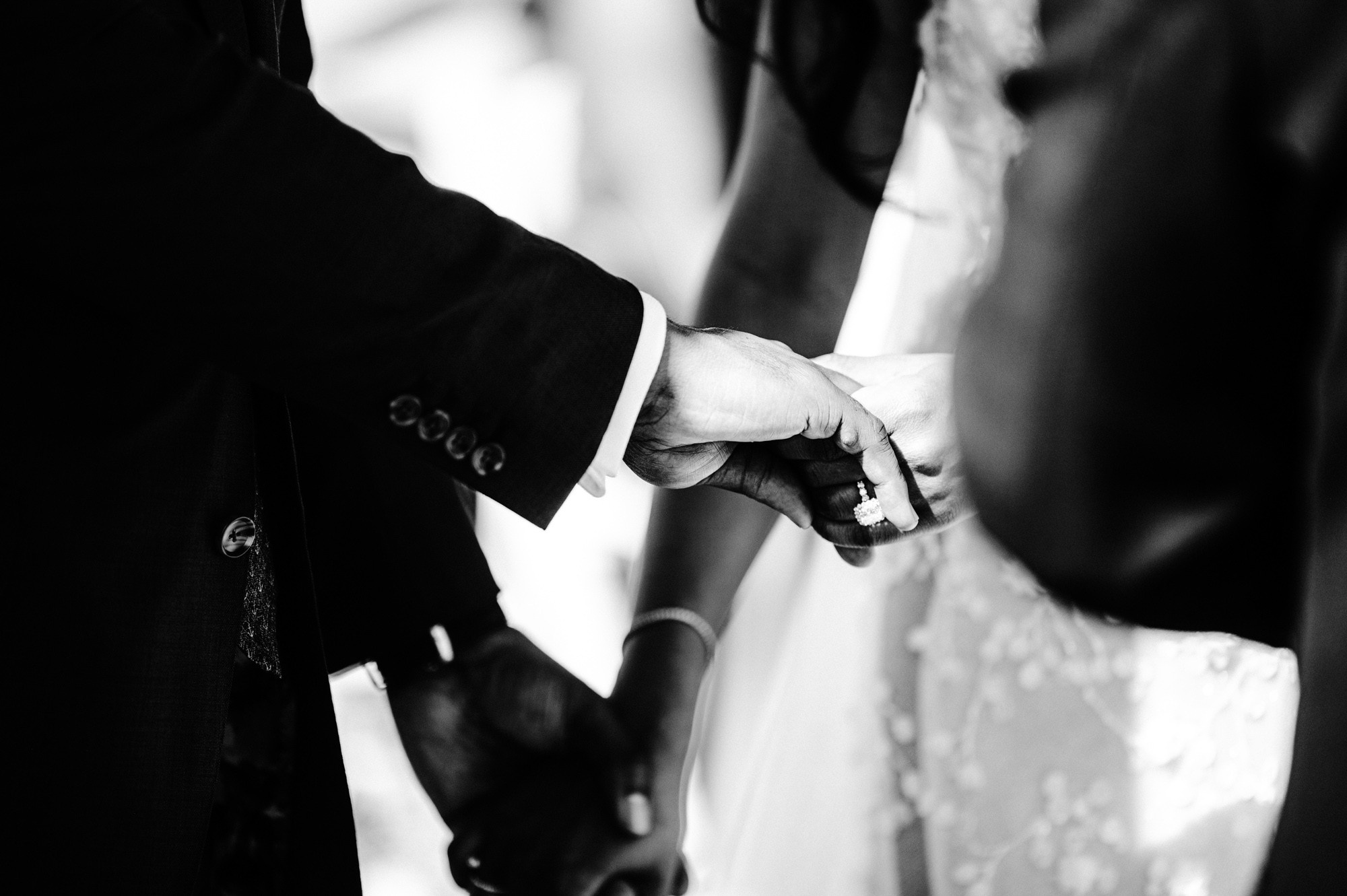 a man and woman holding hands during a wedding ceremony