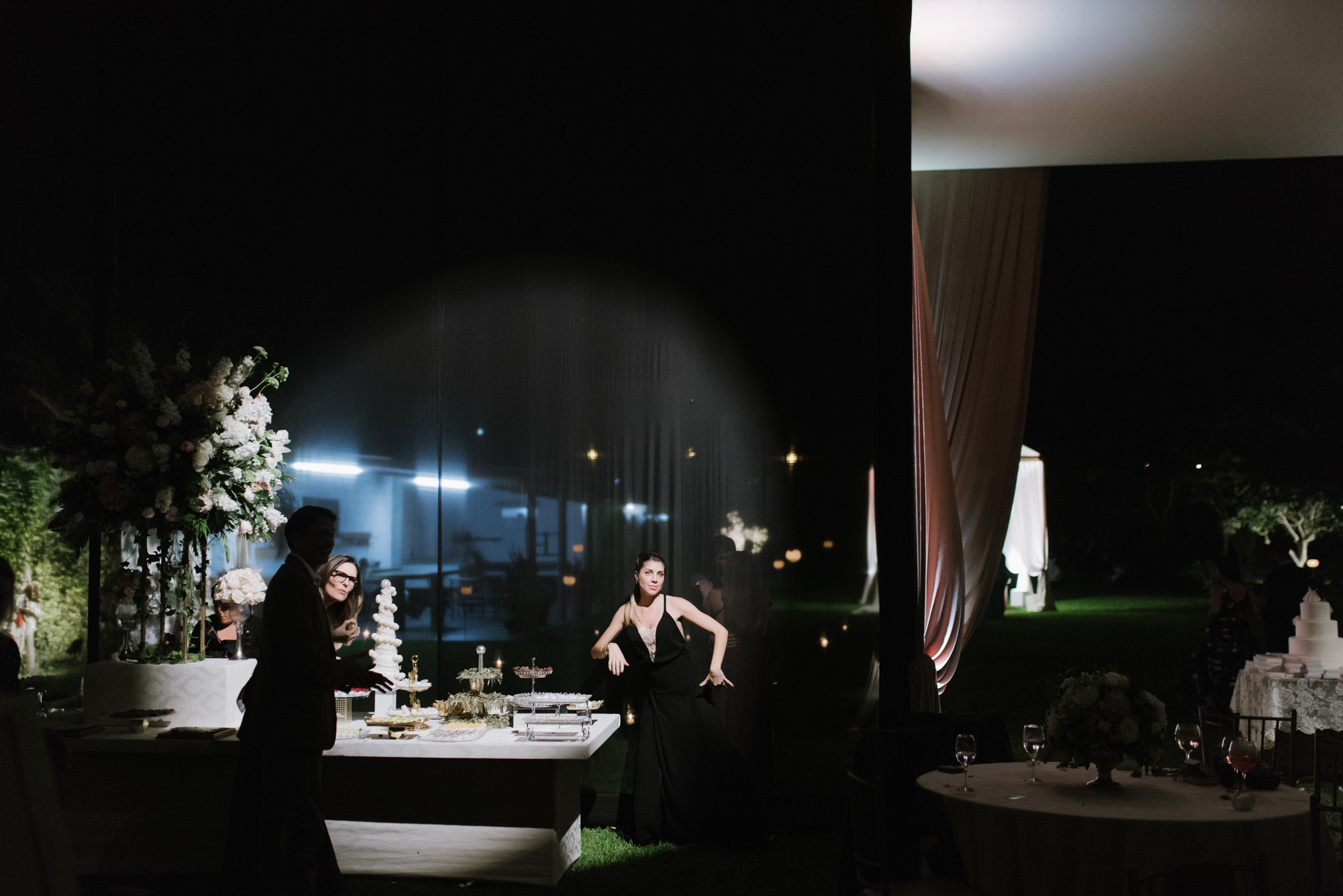 a couple sitting at a table with a cake
