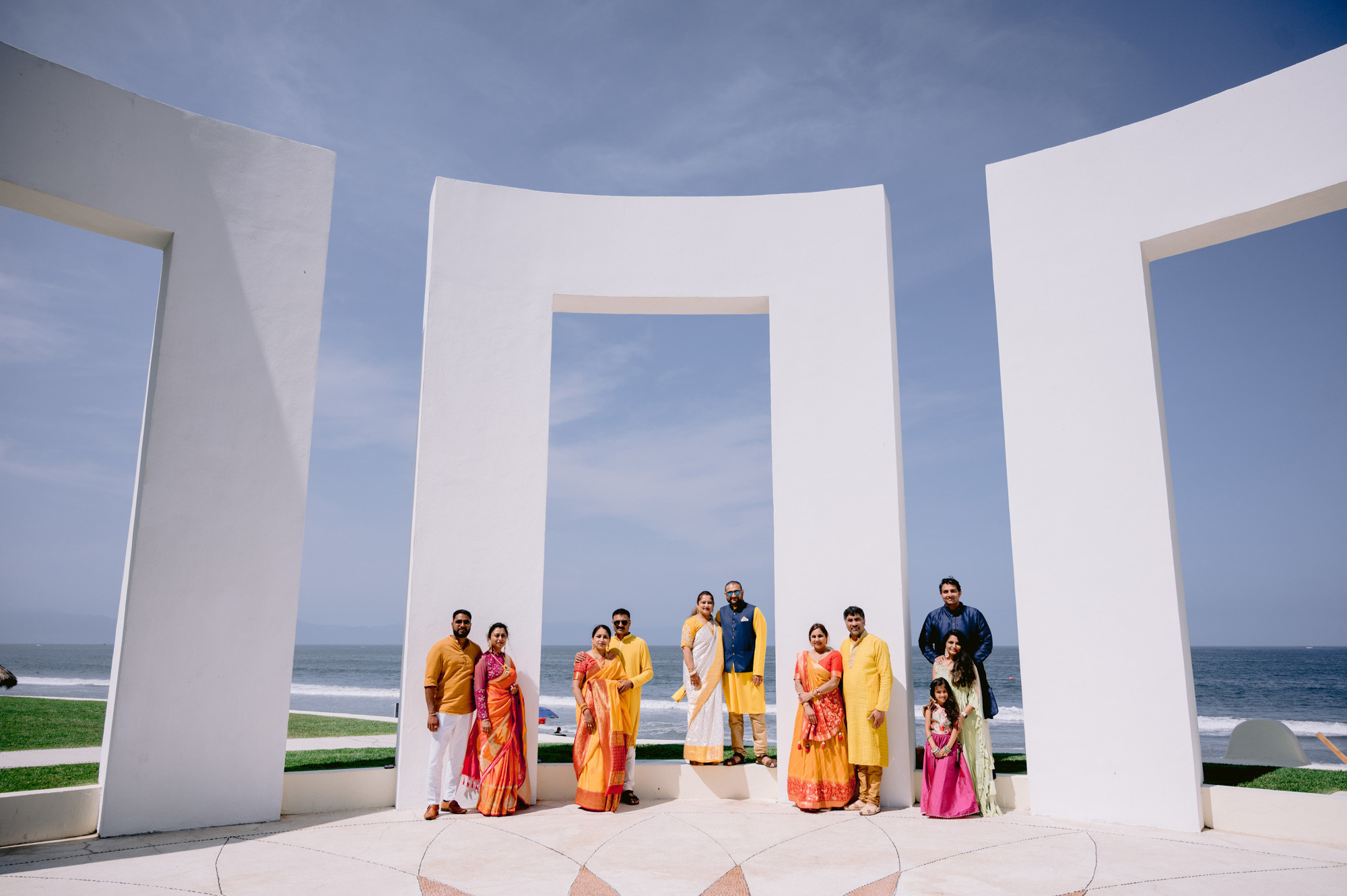 a group of people standing in front of a large white structure