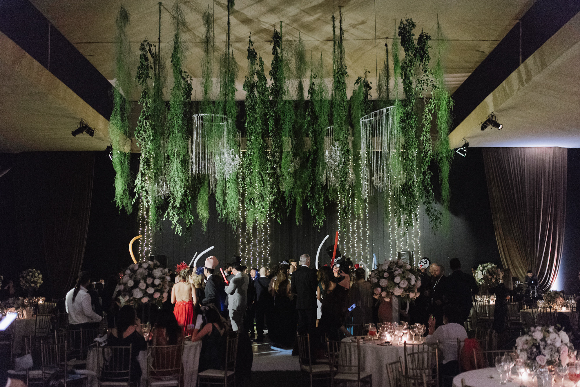 a large room with a bunch of plants hanging from the ceiling