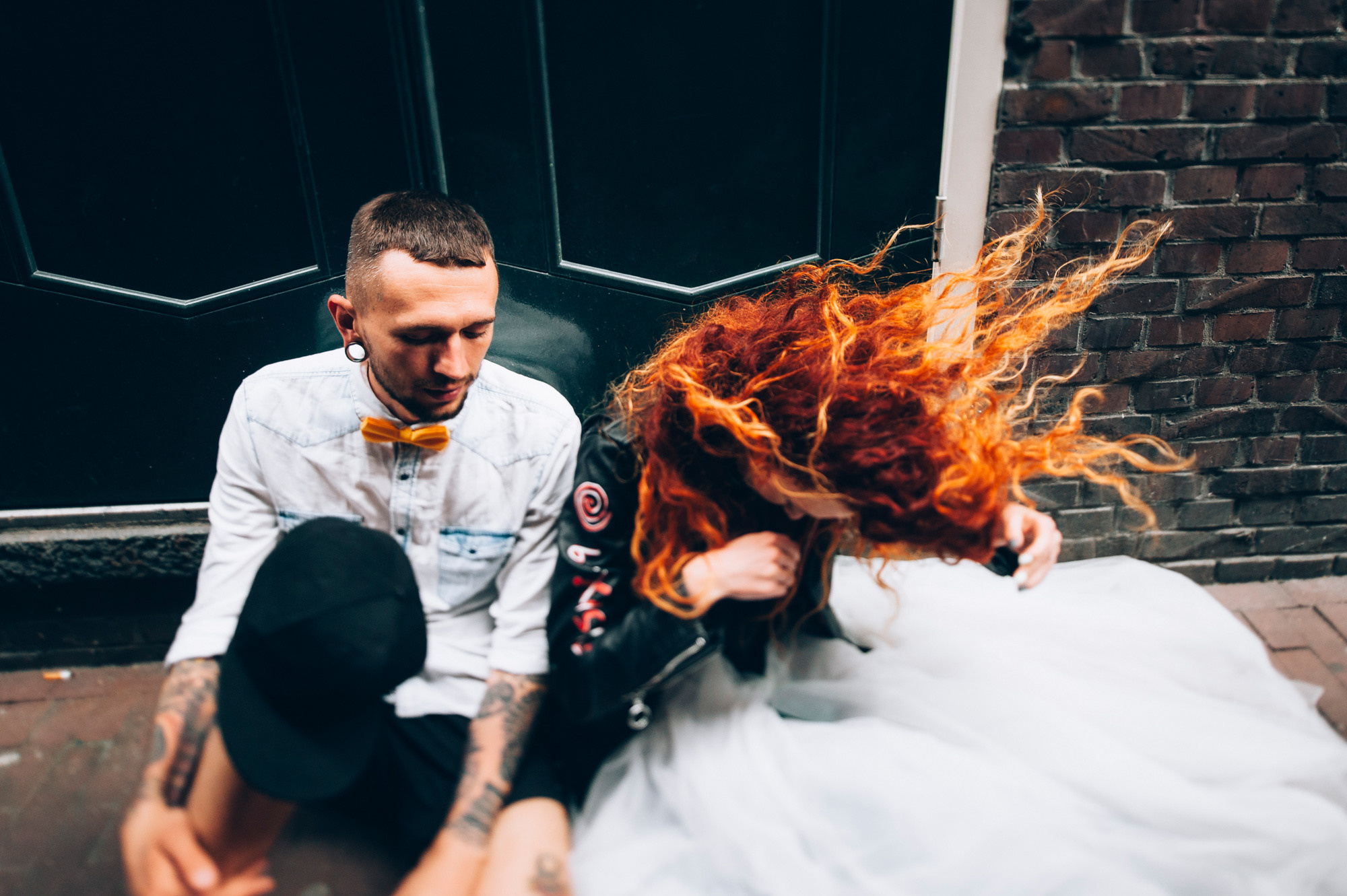 a man and woman sitting on the ground